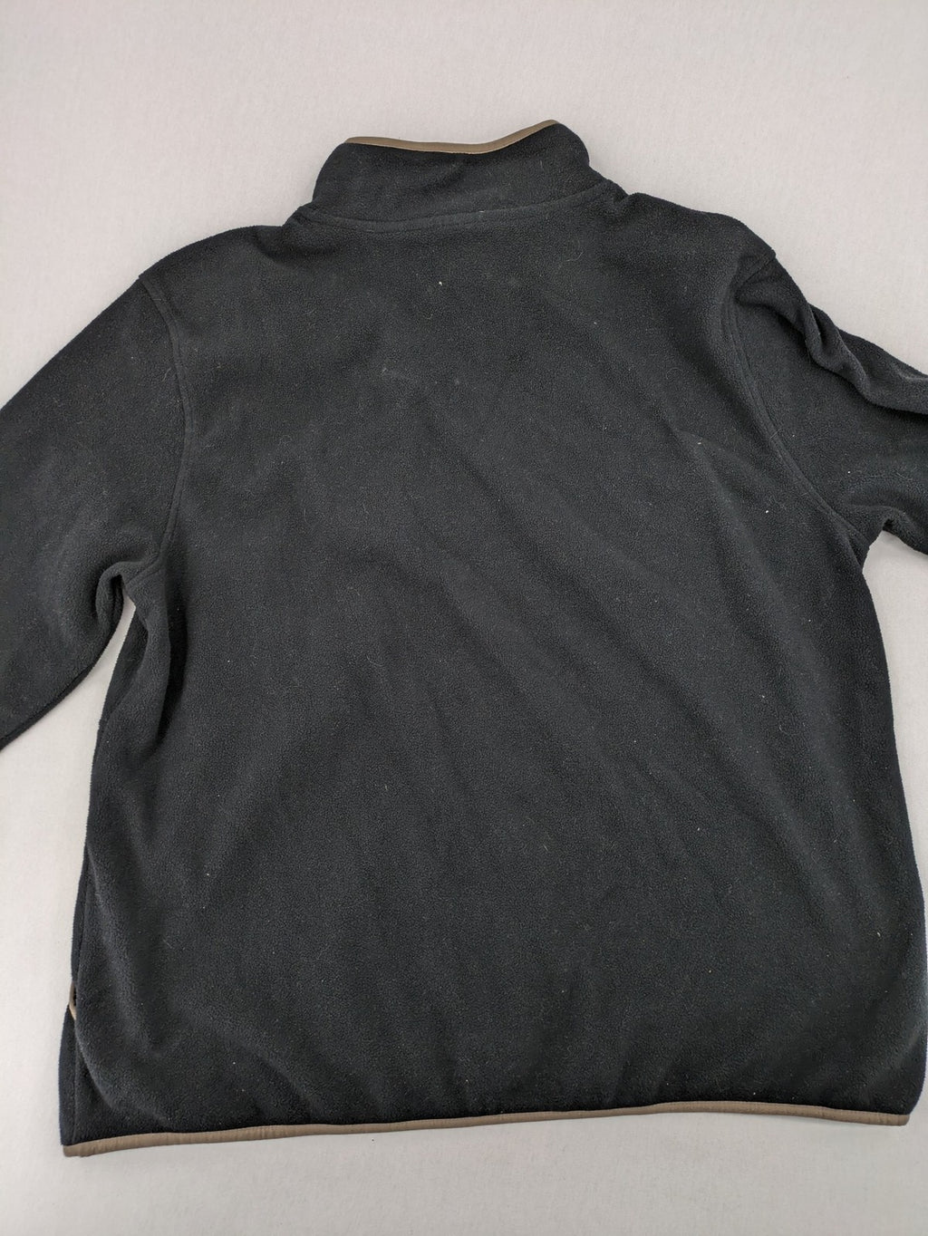 Crane beige and black fleece jacket full zip with cream accents and zippered pockets.