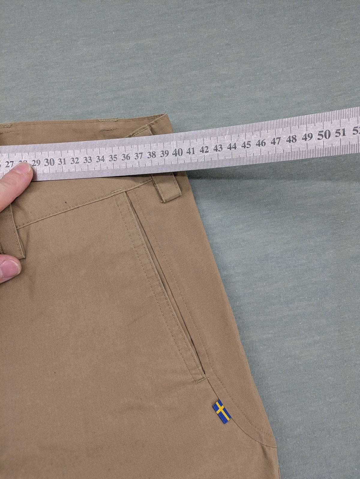 Fjällräven beige pants regular fit durable fabric outdoor style with logo detail.