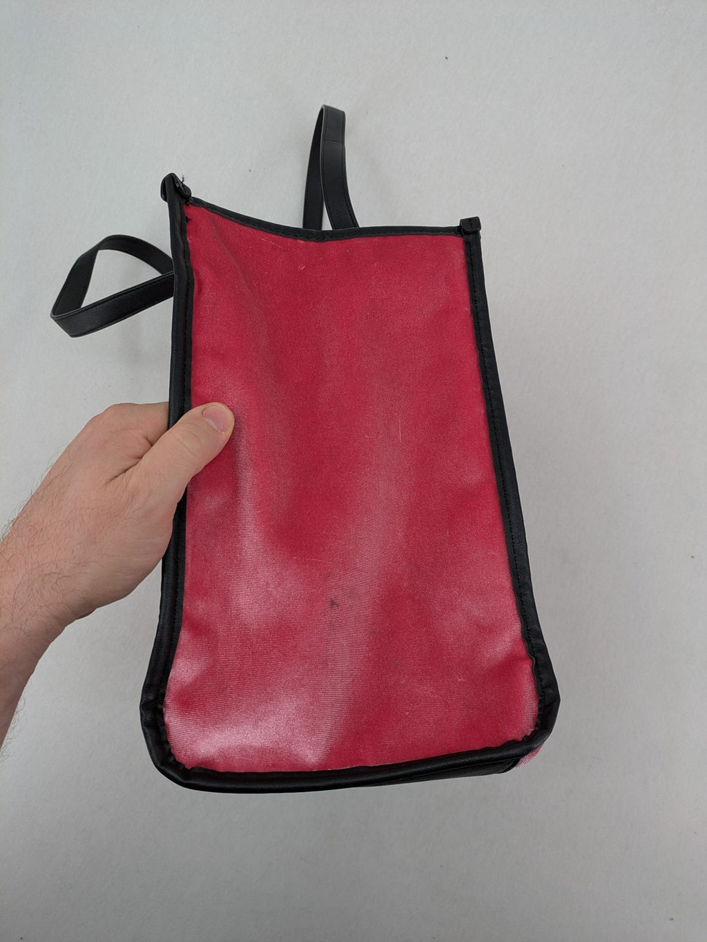 Juicy Couture pink velour handbag with oversized black logo and faux leather straps.