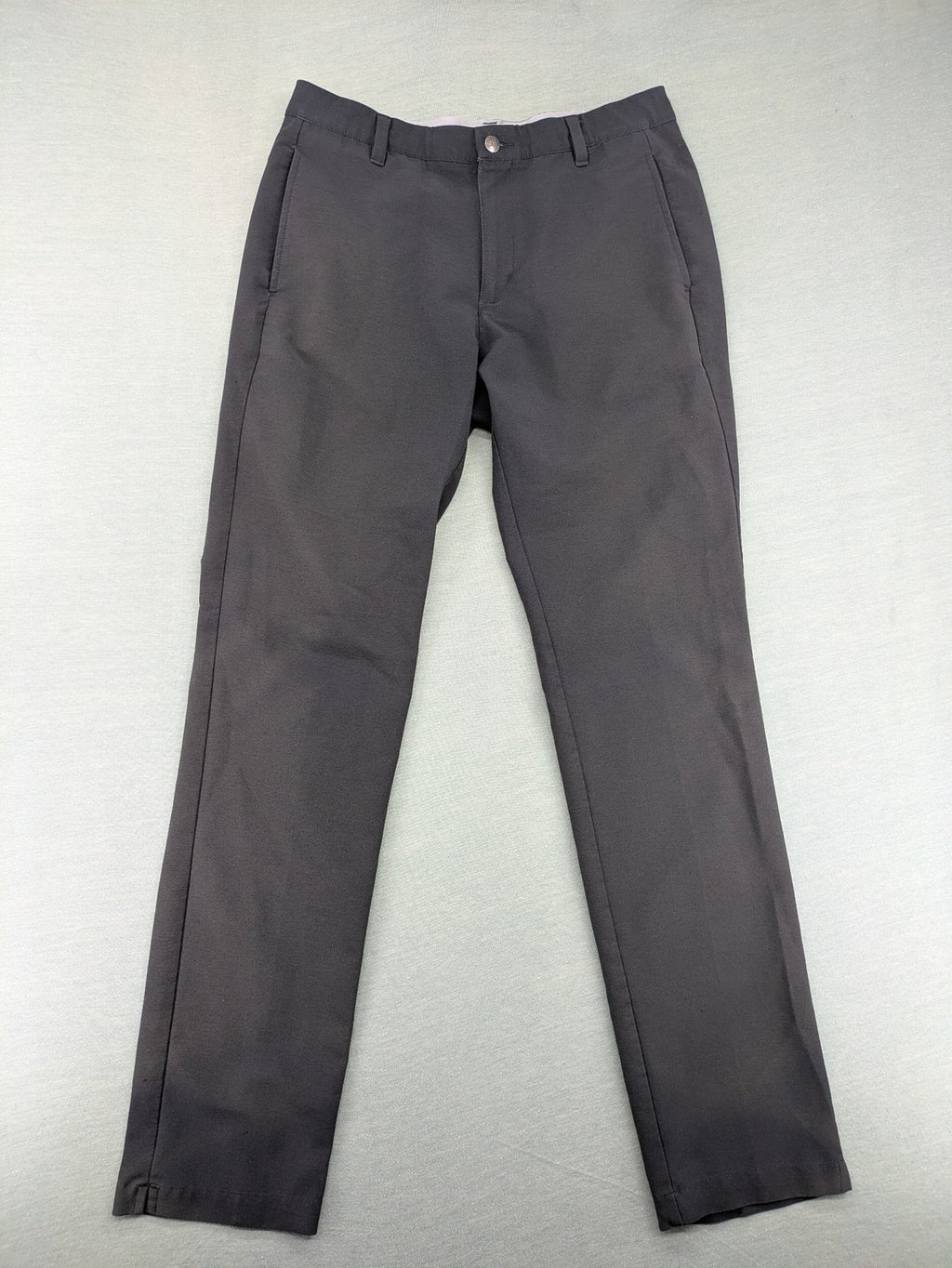 Adidas grey pants with 3-stripe logo, flat-front design, made from performance material.