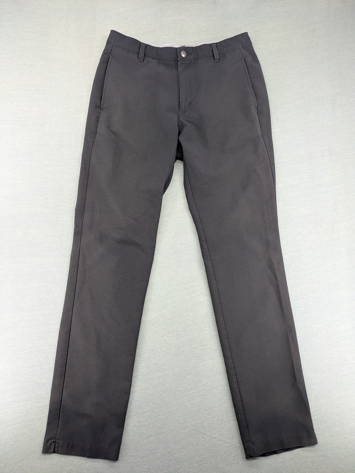 Adidas grey pants with 3-stripe logo, flat-front design, made from performance material.