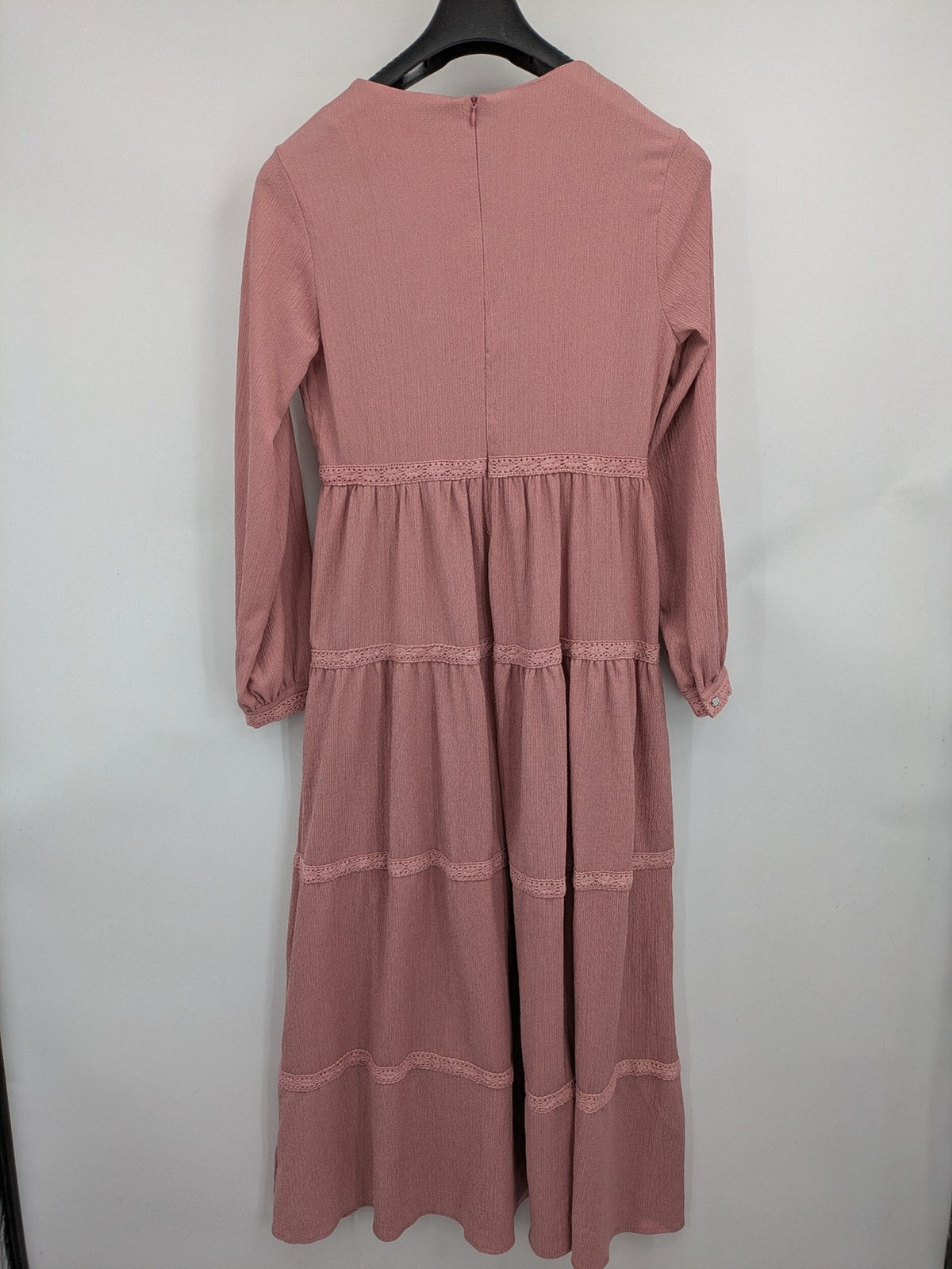 Moda pink bridal party dress with lace inserts, long sleeves, and tiered design.