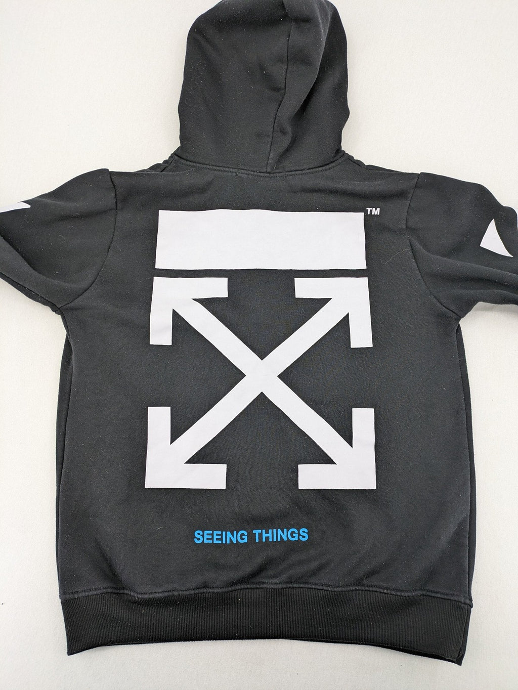 Off-White white zip-through hoodie with diagonal stripes and large arrows graphic.