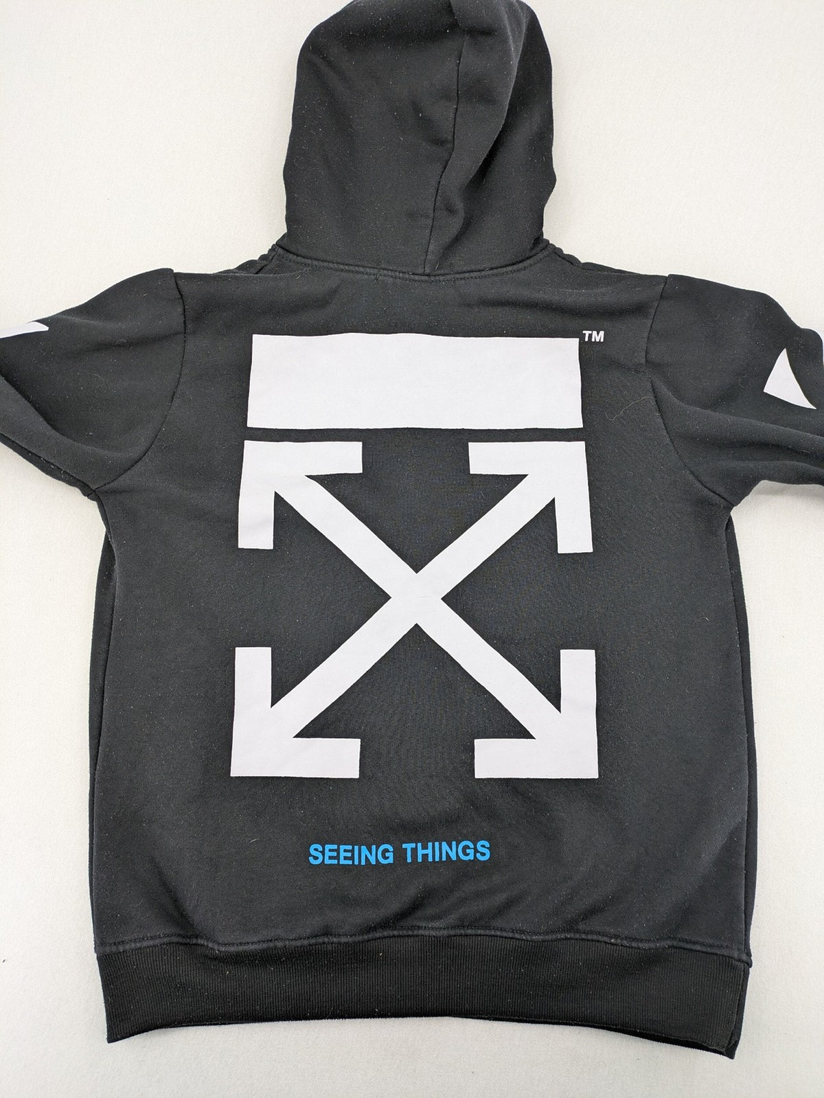 Off-White white zip-through hoodie with diagonal stripes and large arrows graphic.