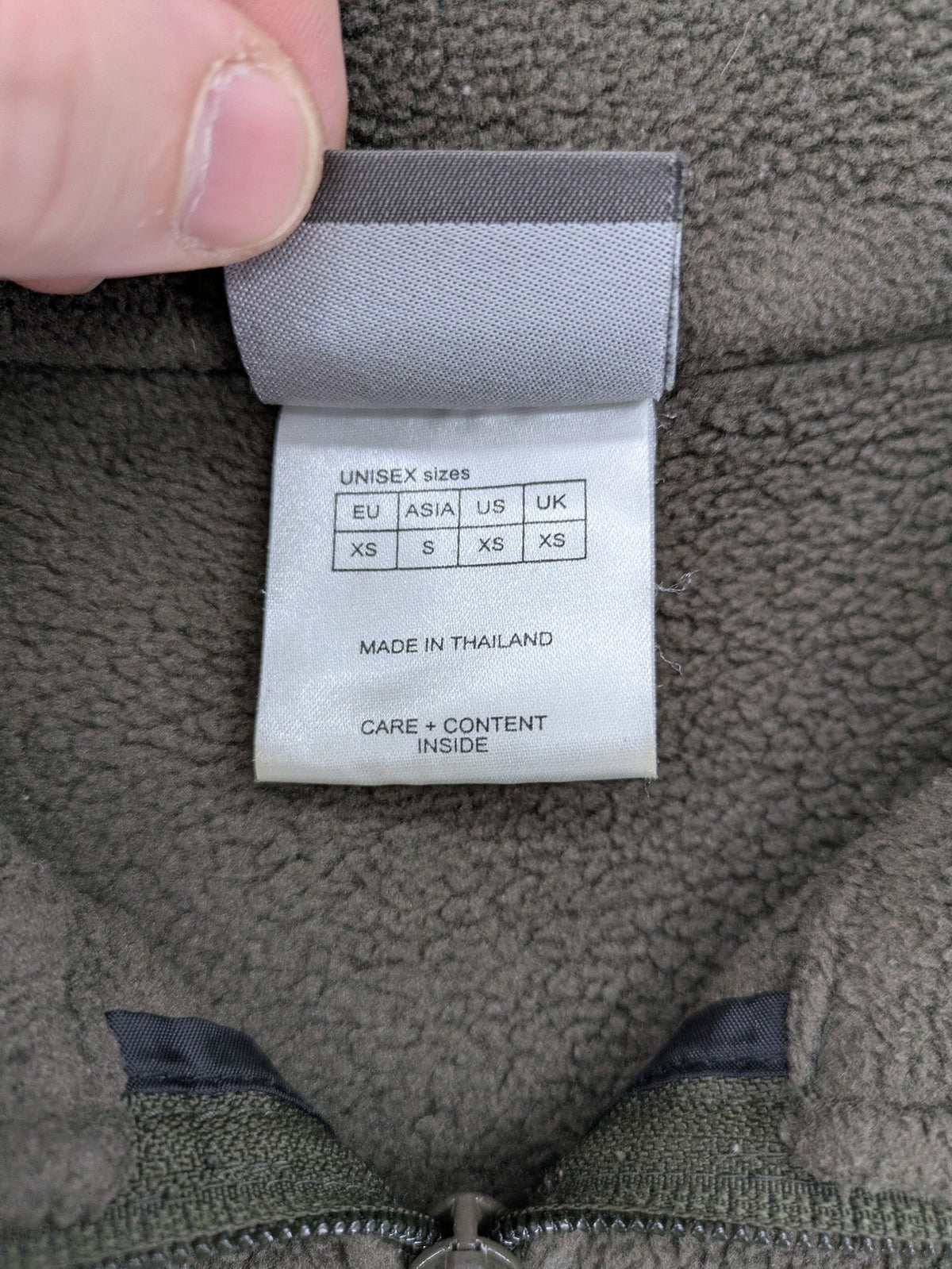 Jack Wolfskin khaki turtle neck jumper with quarter zip and embroidered paw logo.