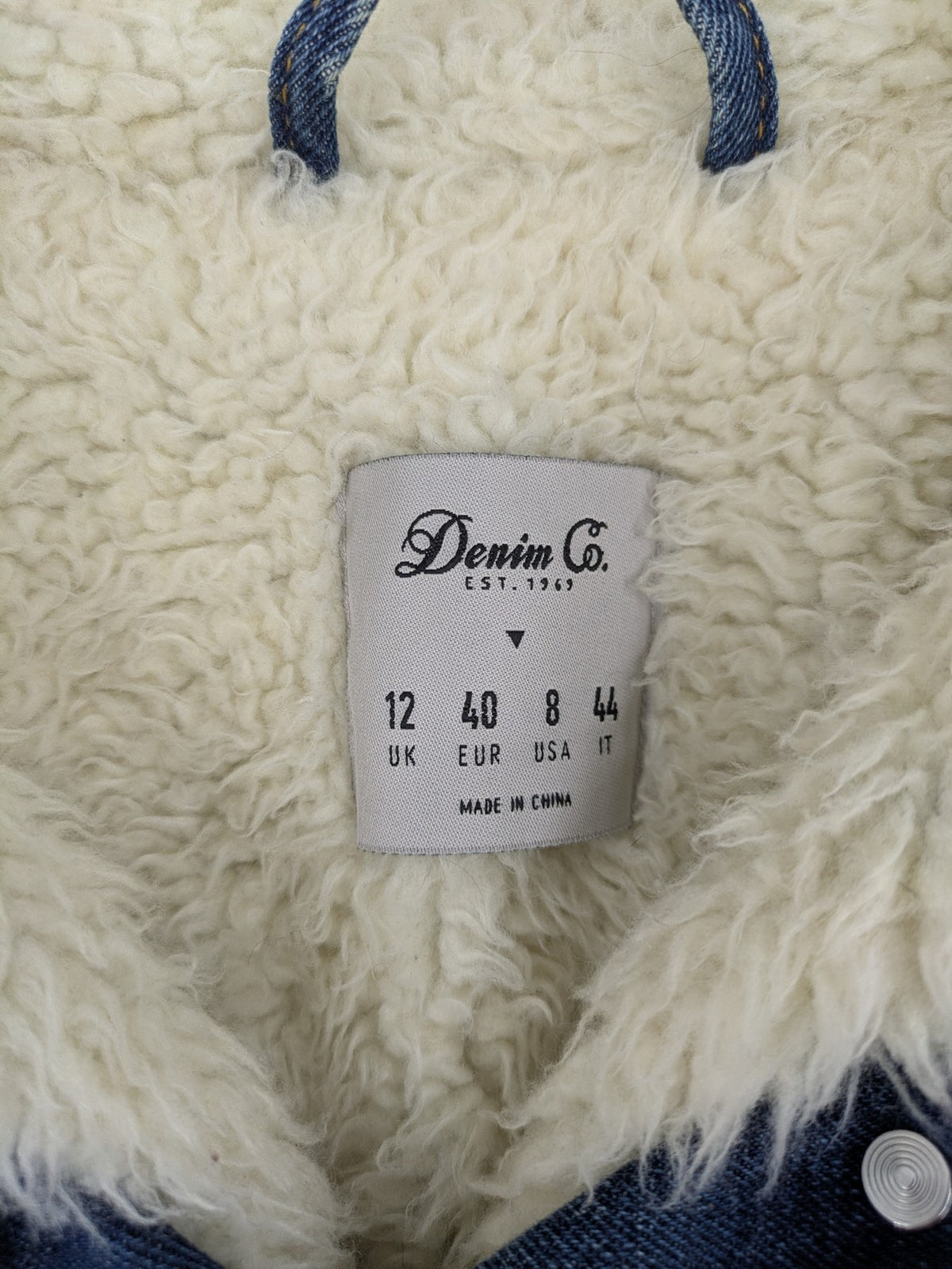 Denim & Co. blue jacket with cream Sherpa lining, button closure, and pockets.
