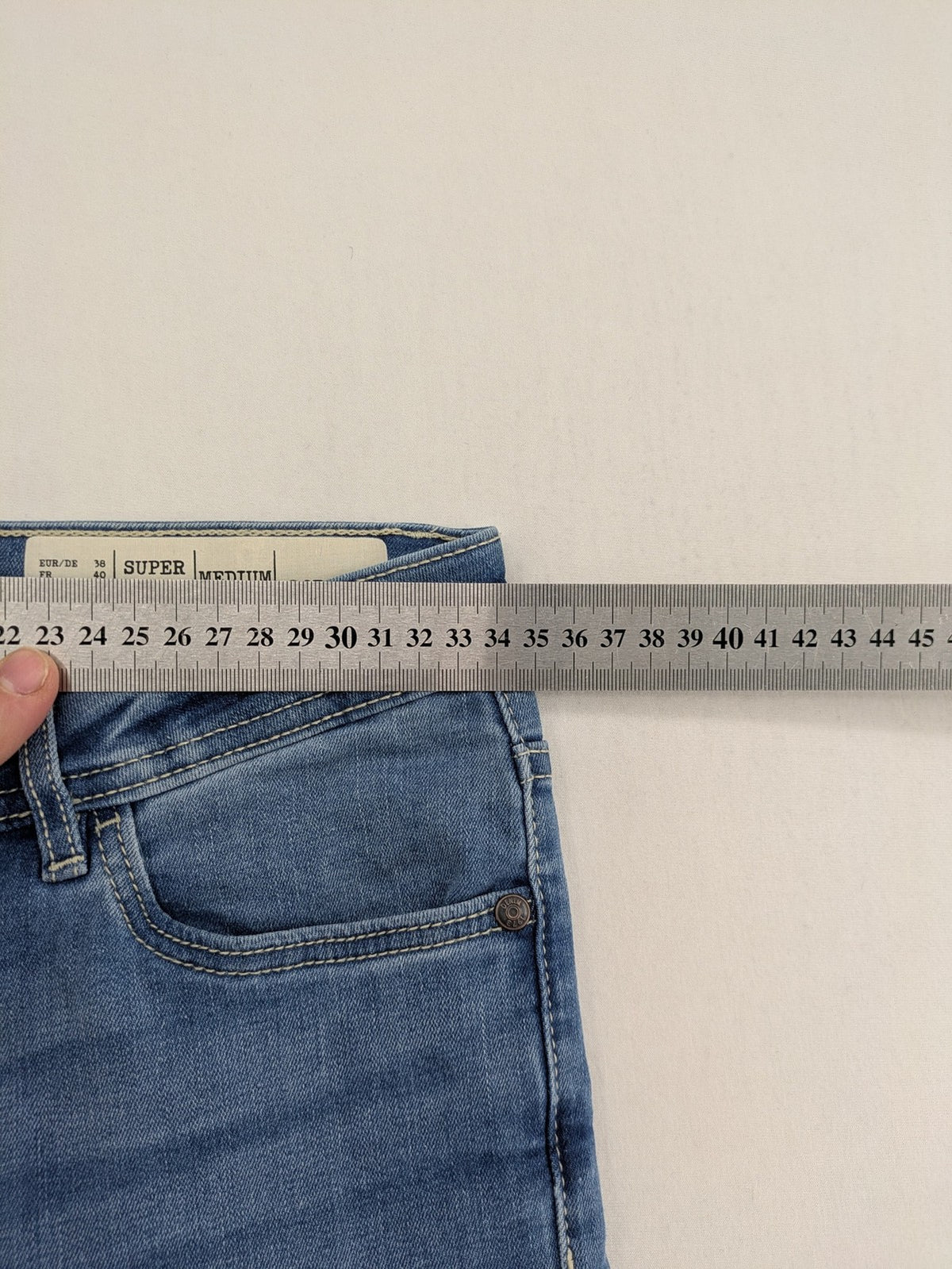 ESMARA blue super skinny jeans with medium waist and stretchy cotton blend material.