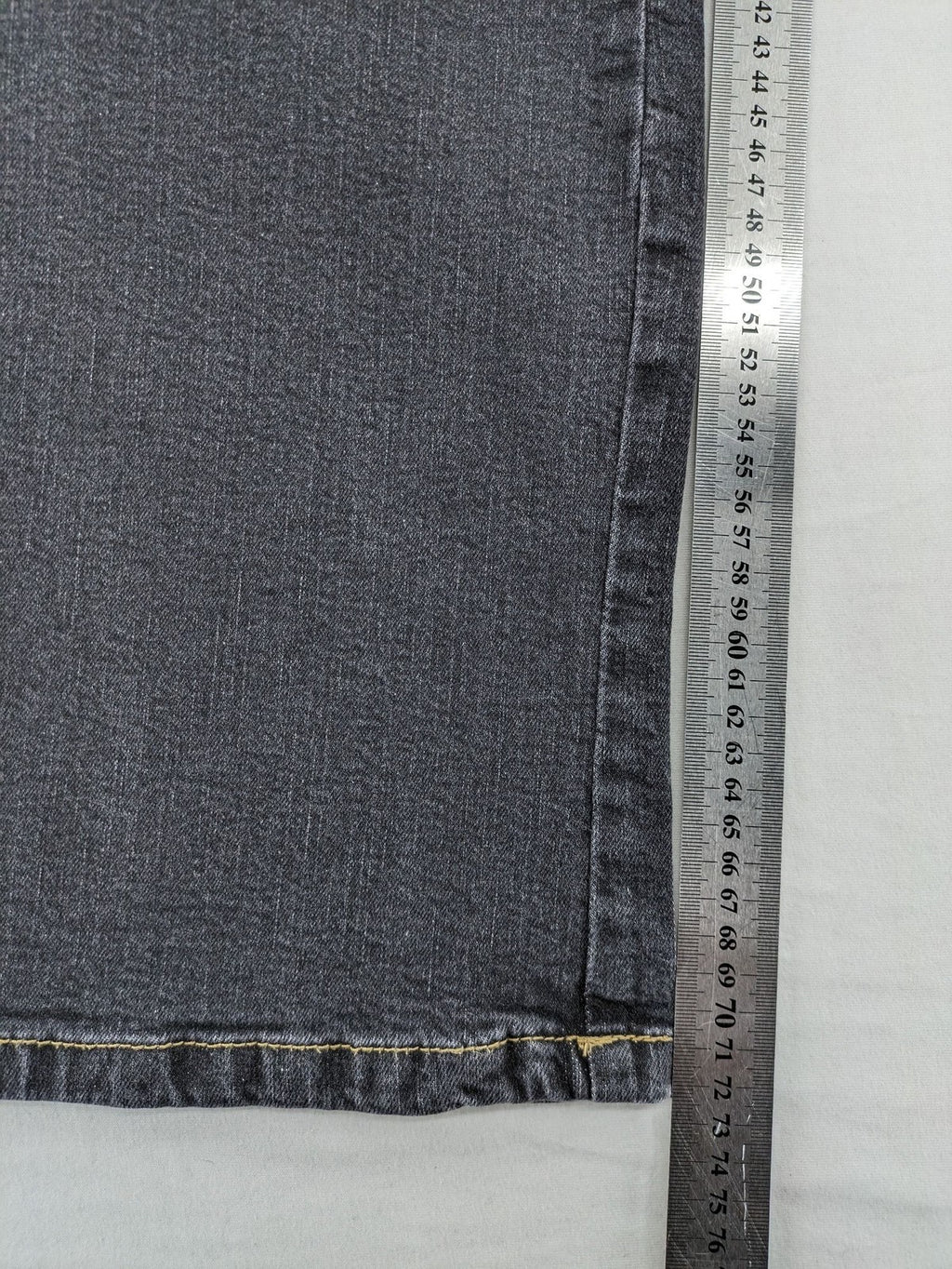Bootcut grey low rise bootcut jeans five-pocket design with zipper and button closure.