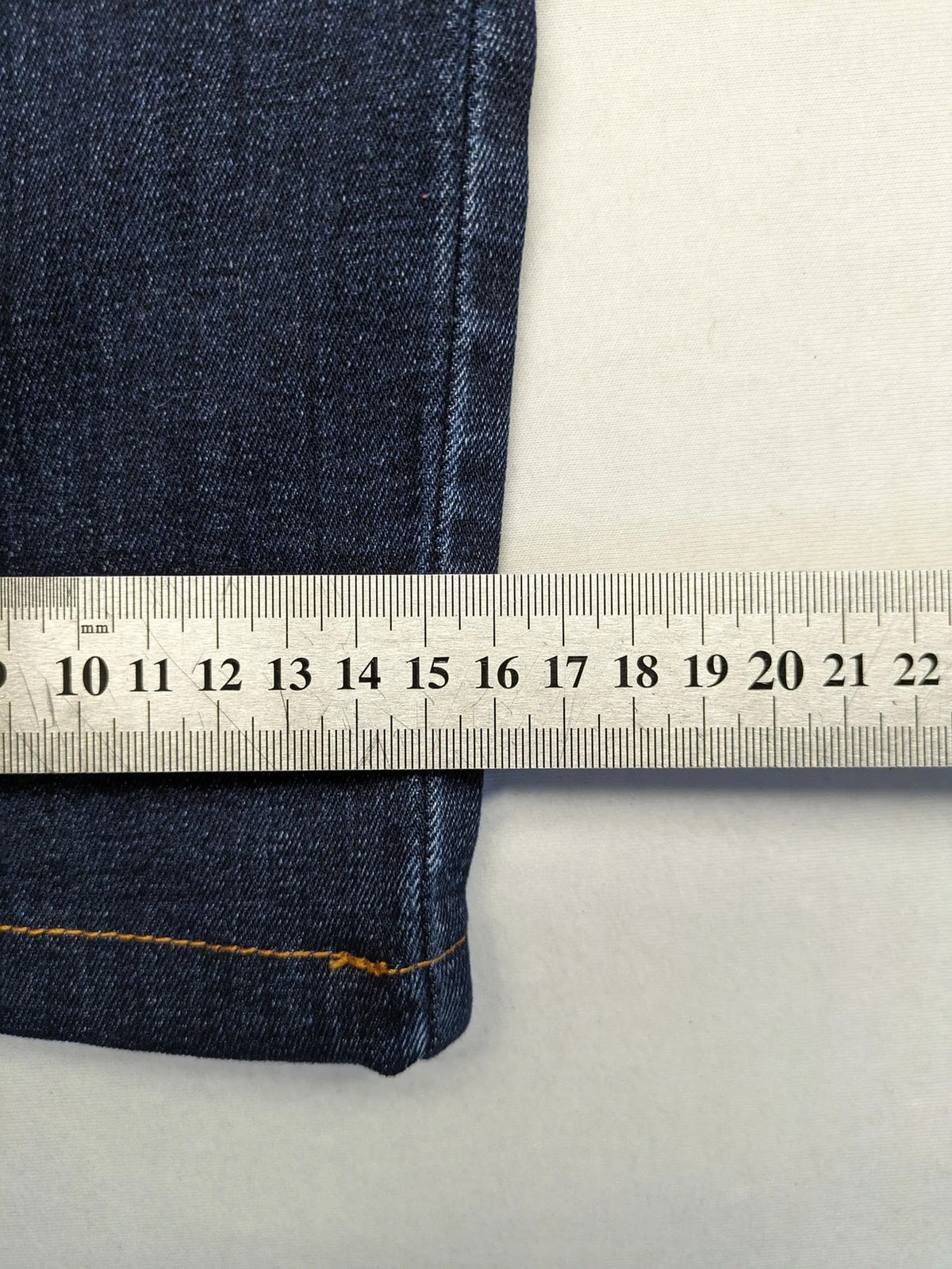 Diesel blue straight jeans with regular waist, dark wash, and stretch material.
