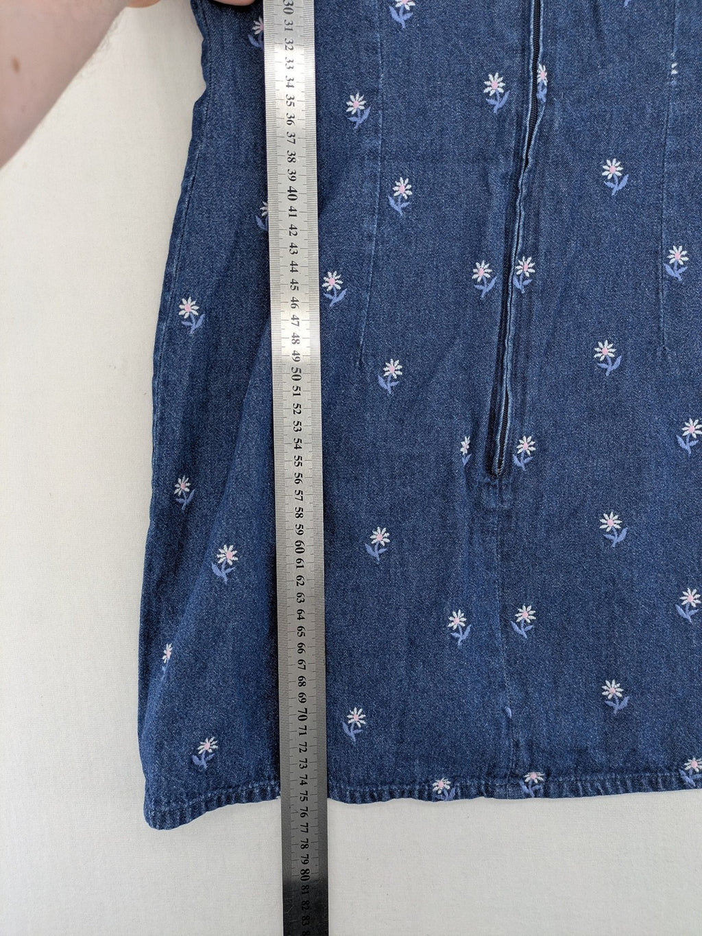 Damen blue denim mini dress with all-over white and light blue floral embroidery.