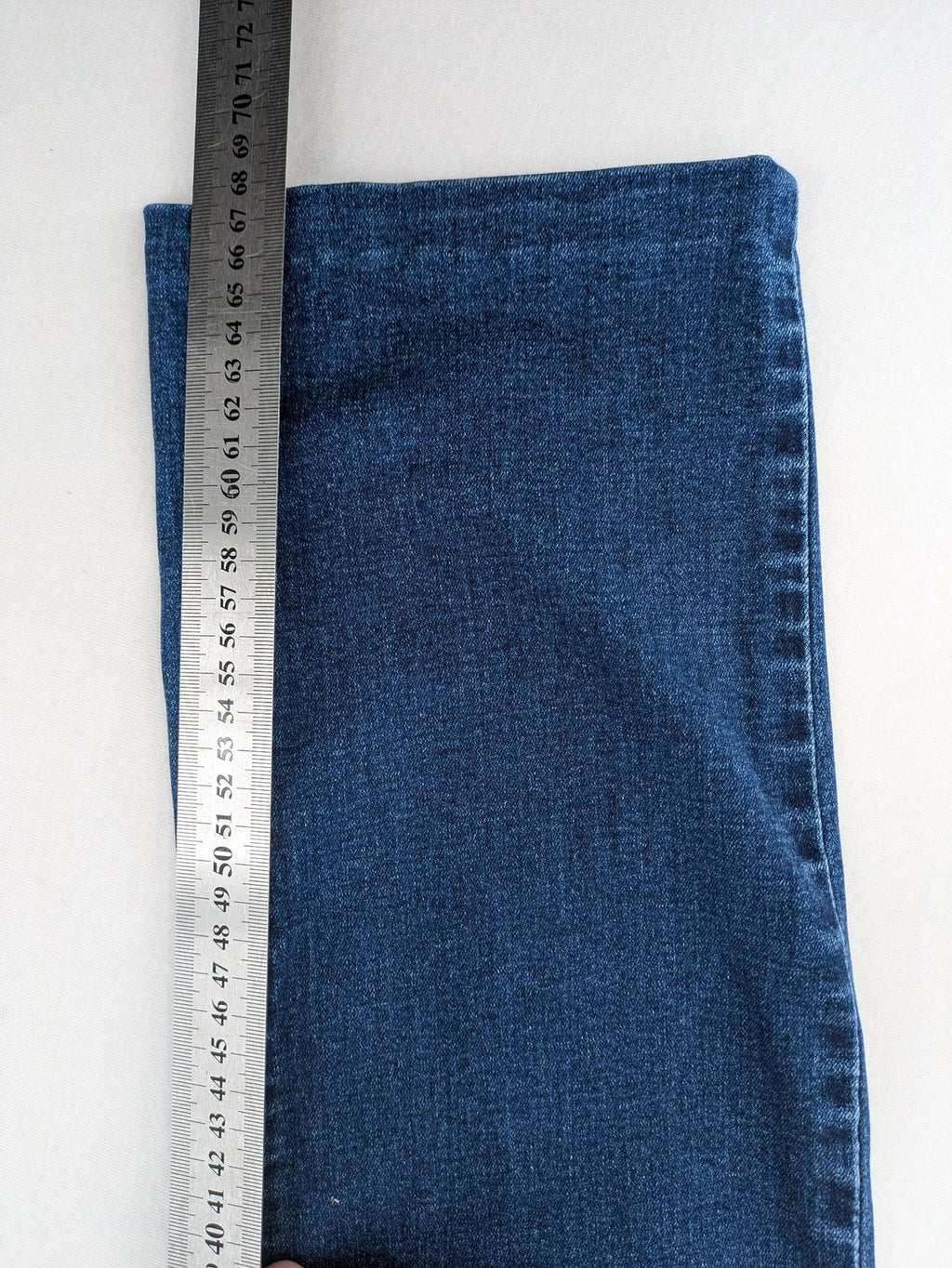 Miss Good blue straight jeans with 5-pocket design and decorative metal accent.