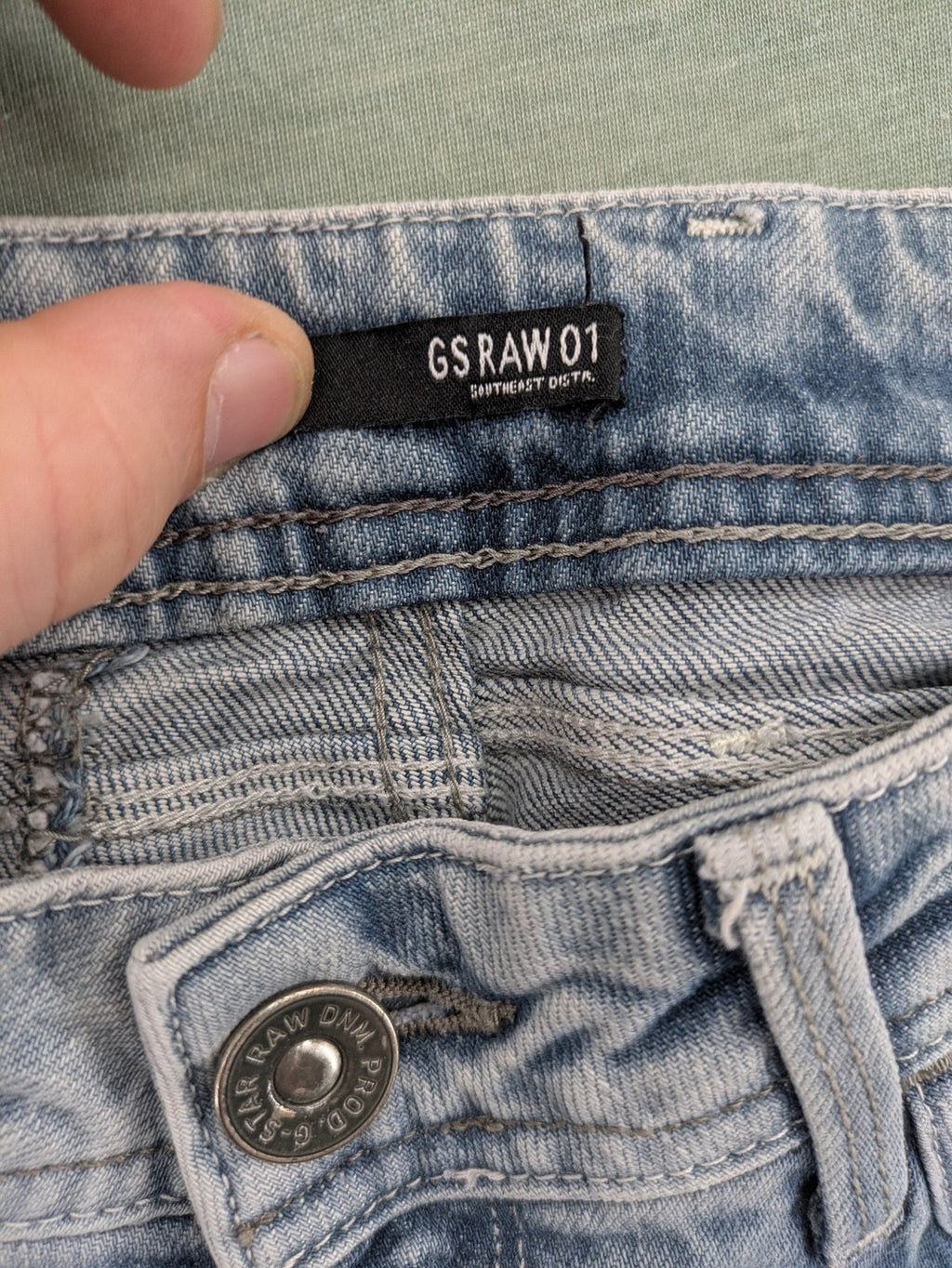 G-Star Raw blue straight leg jeans with classic 5-pocket design and light wash denim.