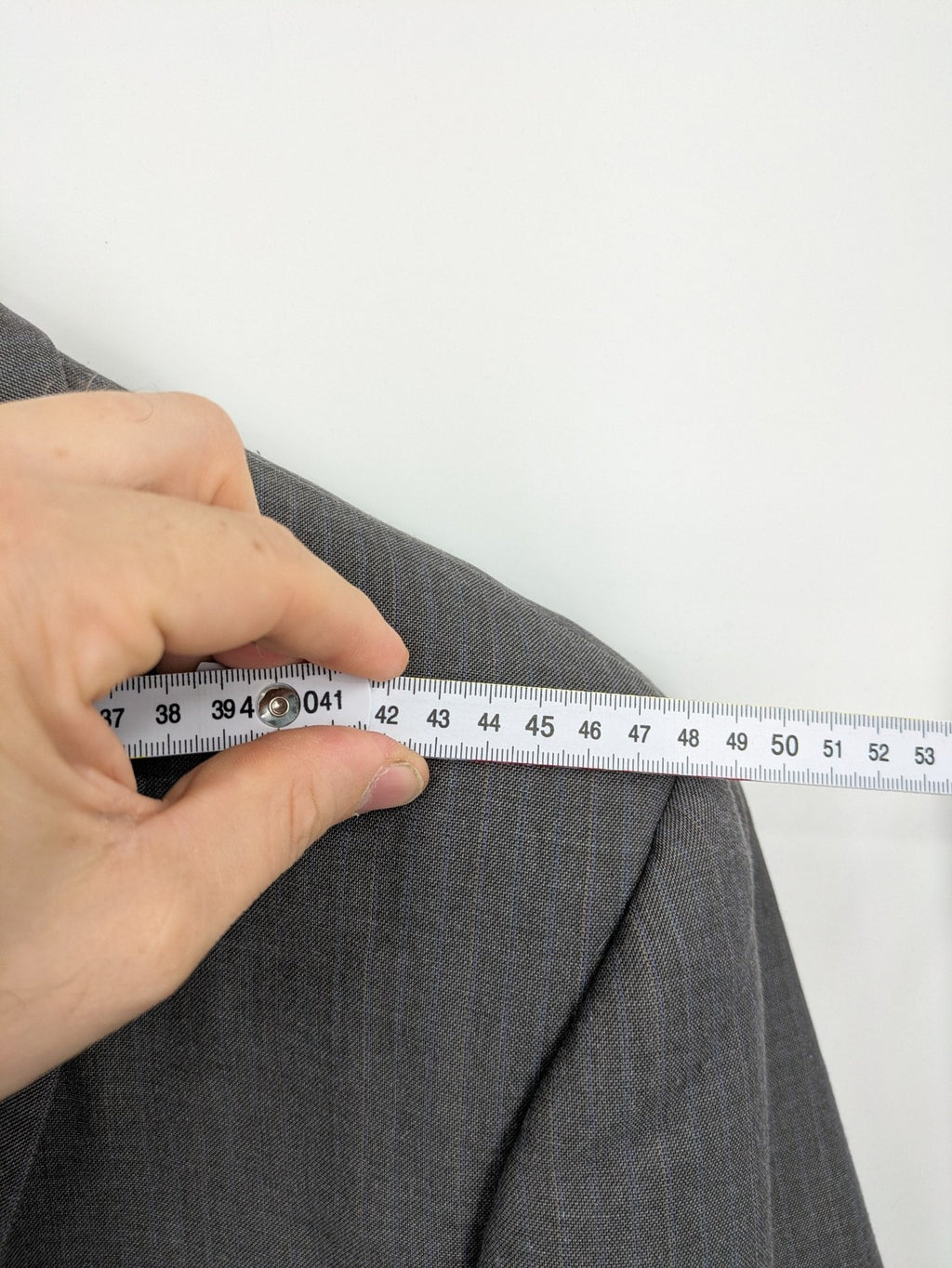 Alextrading grey jacket with subtle light blue pinstripe pattern and notch lapels.
