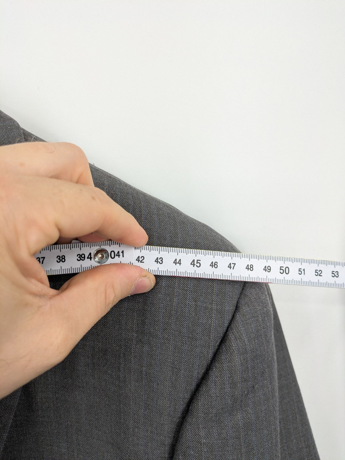 Alextrading grey jacket with subtle light blue pinstripe pattern and notch lapels.