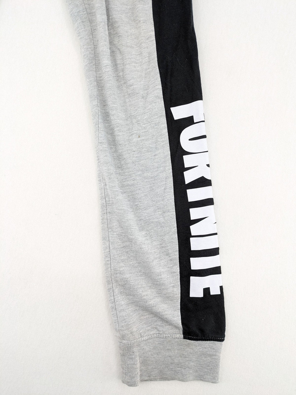 Fortnite pants grey with black side stripes and large logo print, cotton blend material.