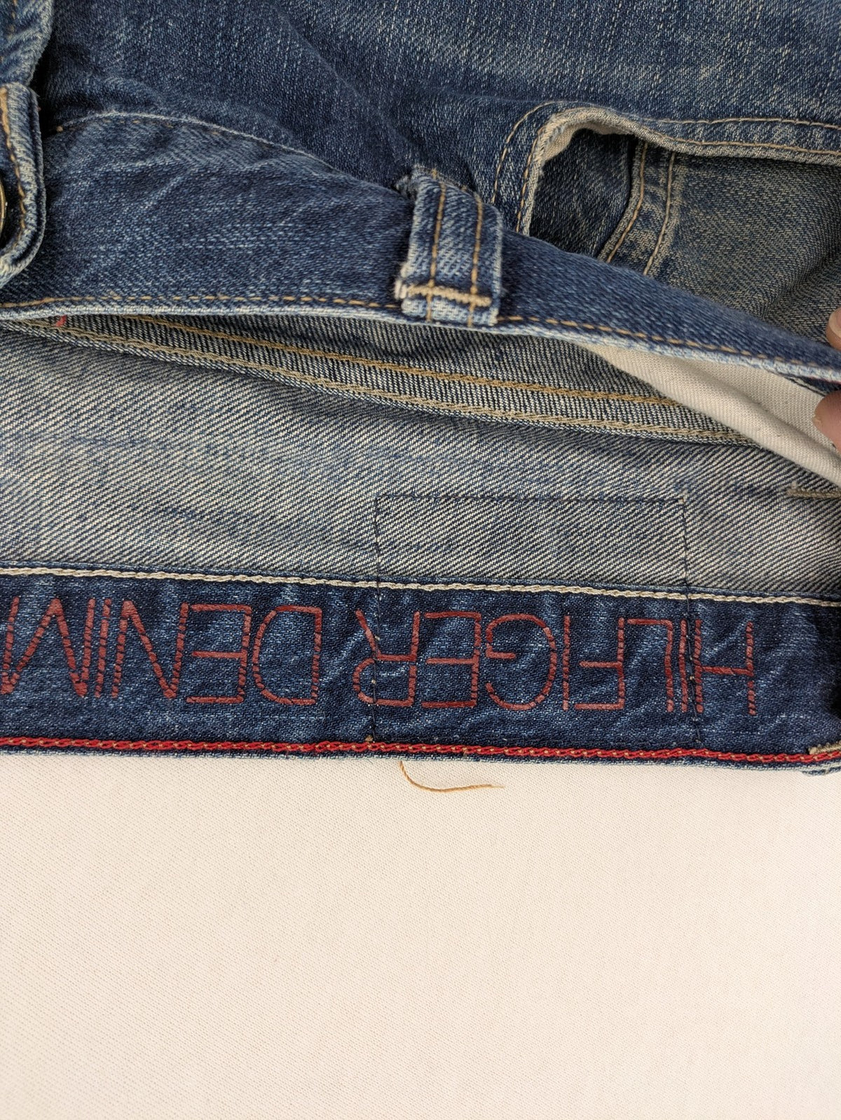 Hilfiger Denim blue straight jeans faded wash with Tommy Hilfiger flag logo on pocket.