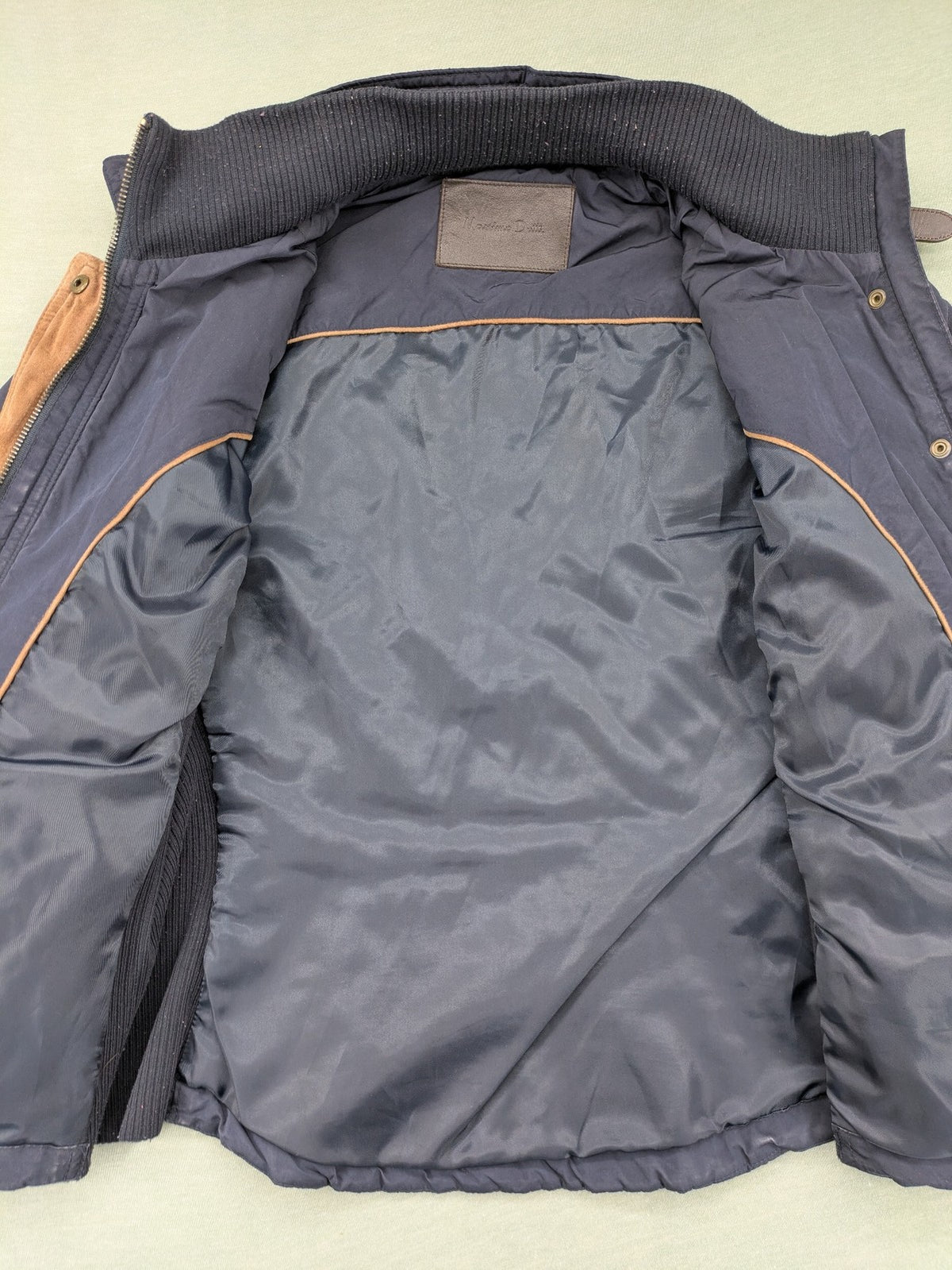 Massimo Dutti black quilted jacket with contrasting brown trim and ribbed side inserts.