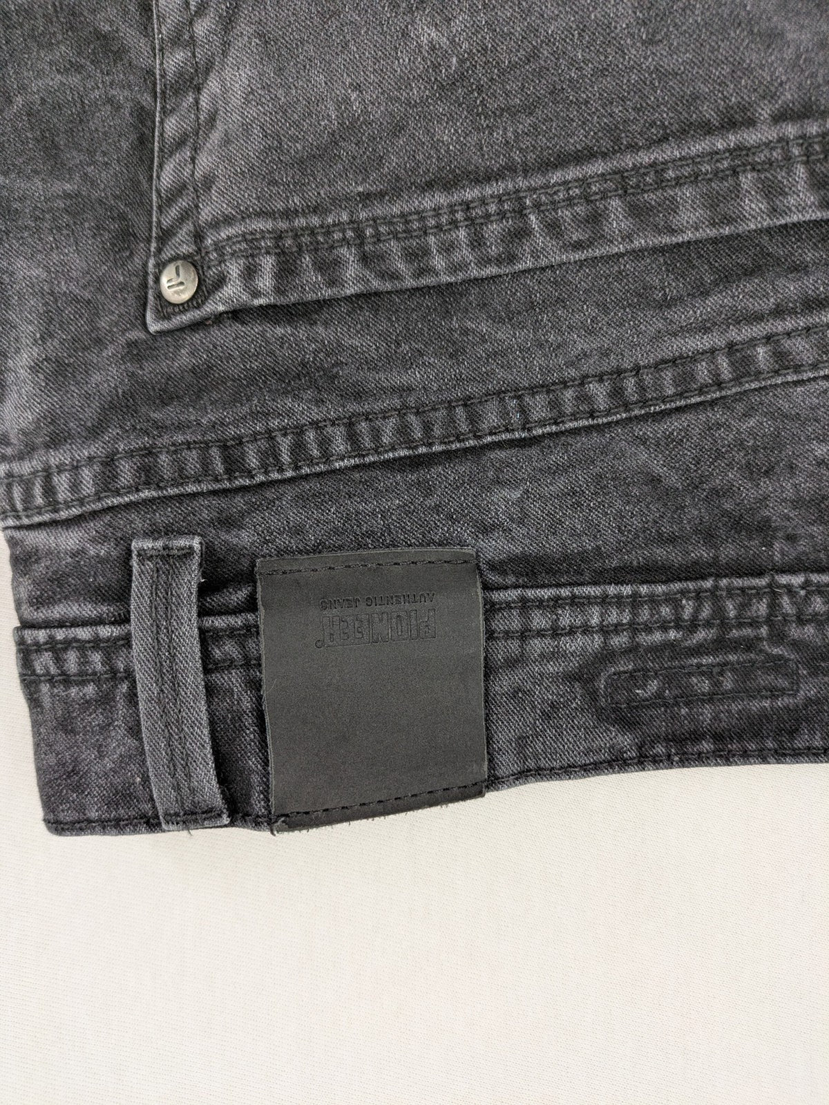 Pioneer grey straight jeans with washed finish and stretch material, classic design.