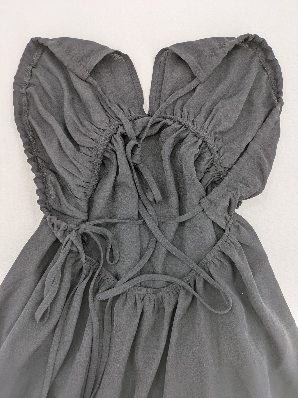 SHEIN grey mini dress with open back, adjustable tie, and ruffled hem.