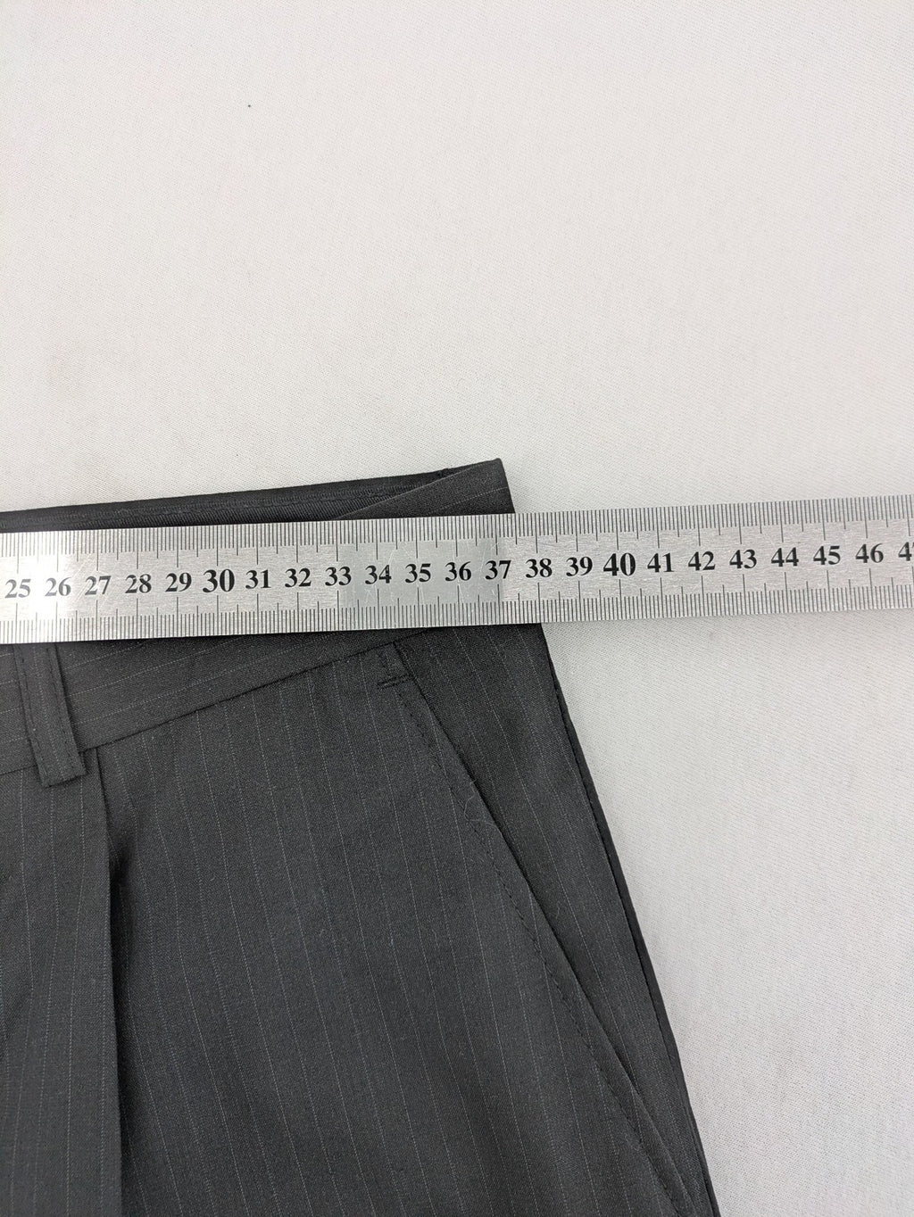 Wahl grey dress pants with pinstripe pattern and pleats, featuring side and back pockets.