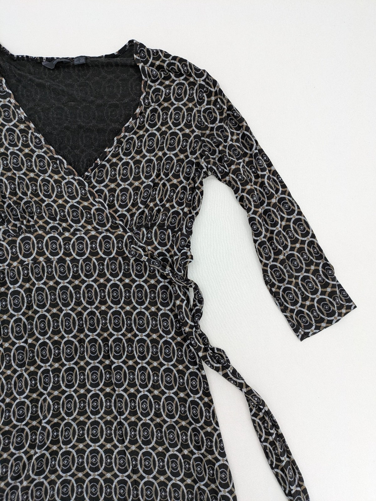 TCM pink wrap dress with V-neck, 3/4 sleeves, geometric black, white, and brown pattern.