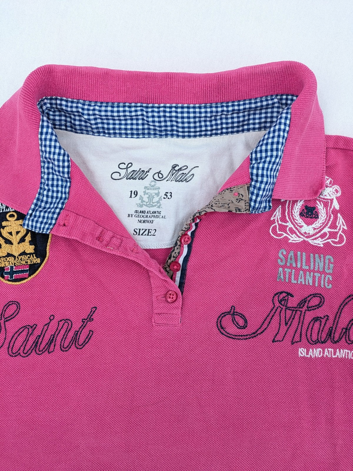 Geographical Norway pink polo shirt with embroidered Saint Malo design and Gingham trim.