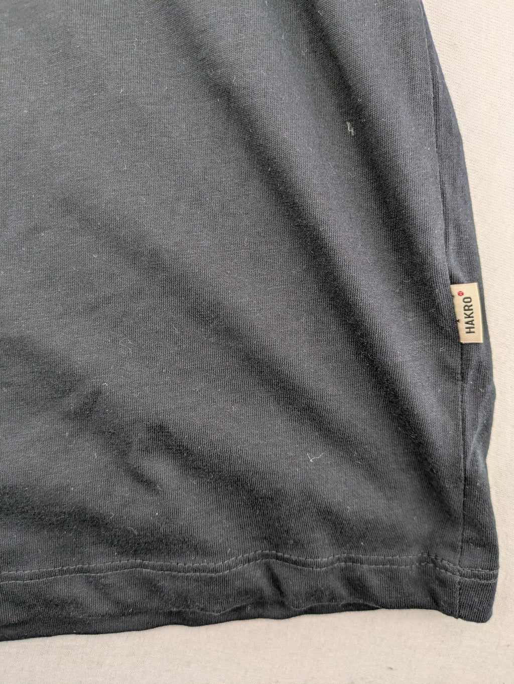 HAKRO blue and grey T-shirt with embroidered TAC Training logo on chest.