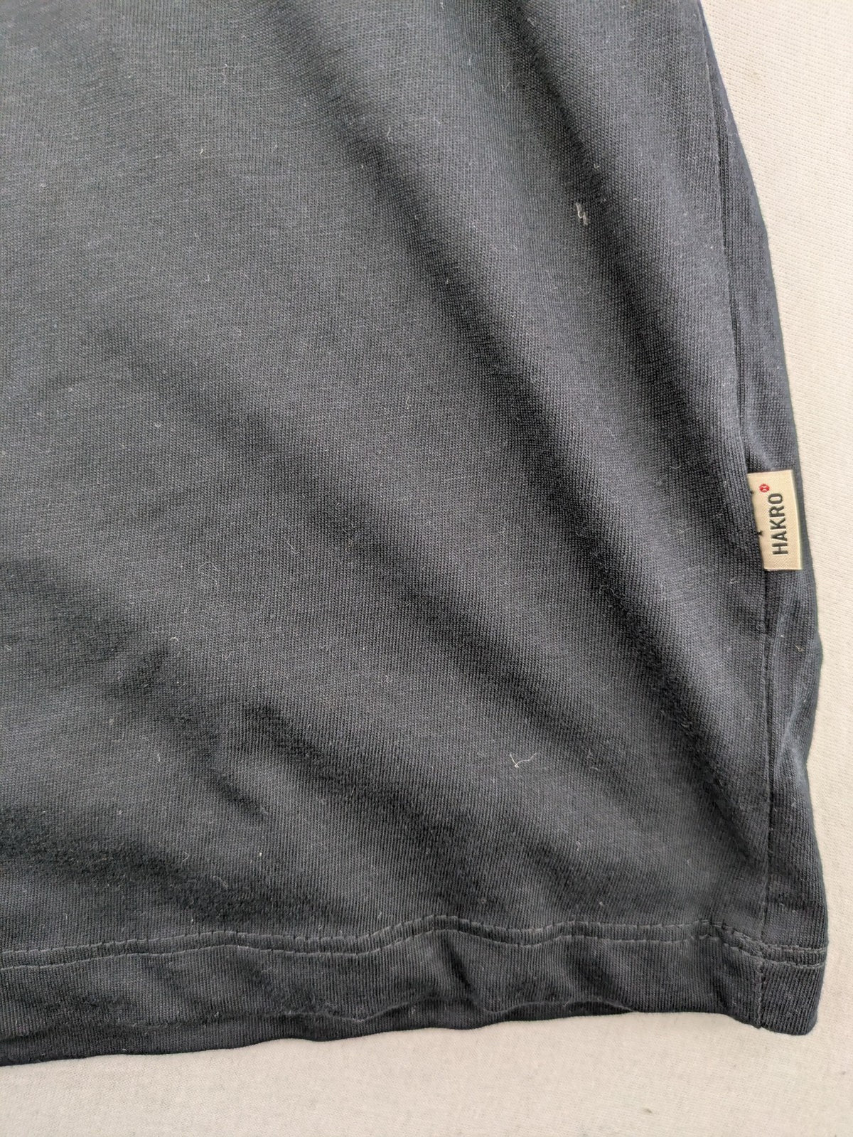 HAKRO blue and grey T-shirt with embroidered TAC Training logo on chest.