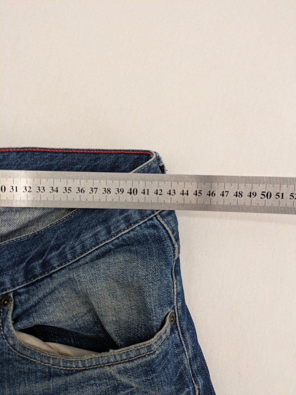 Hilfiger Denim blue straight jeans faded wash with Tommy Hilfiger flag logo on pocket.