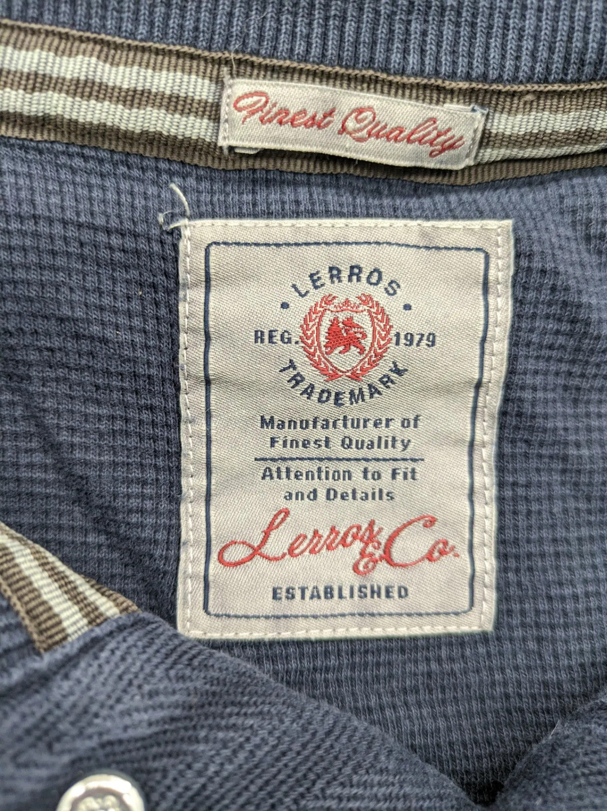 Lerros blue turtle neck jumper with stitched 'British Columbia' detail and button accents.