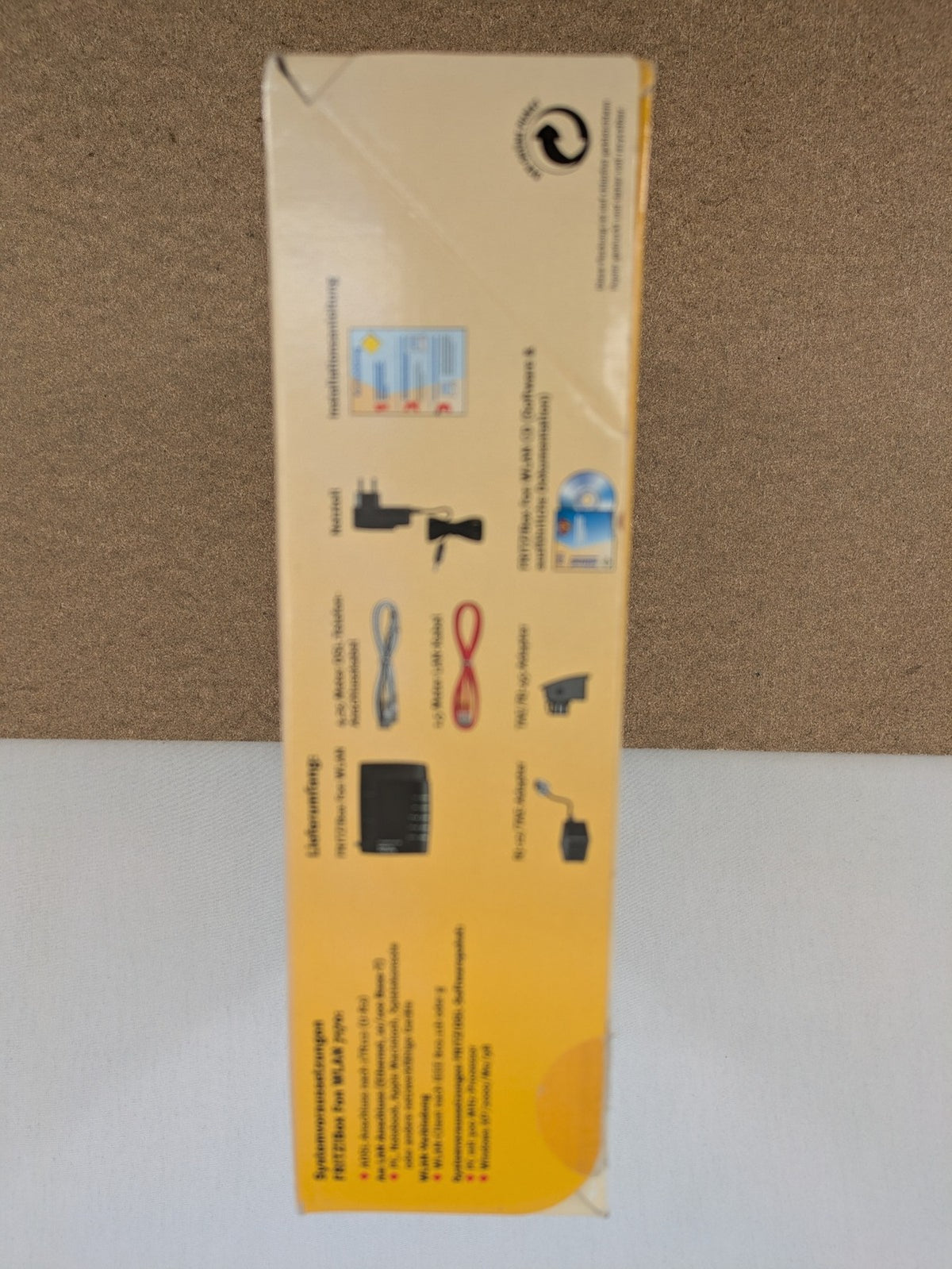 AVM wireless router black grey yellow with logo and integrated DSL modem features.
