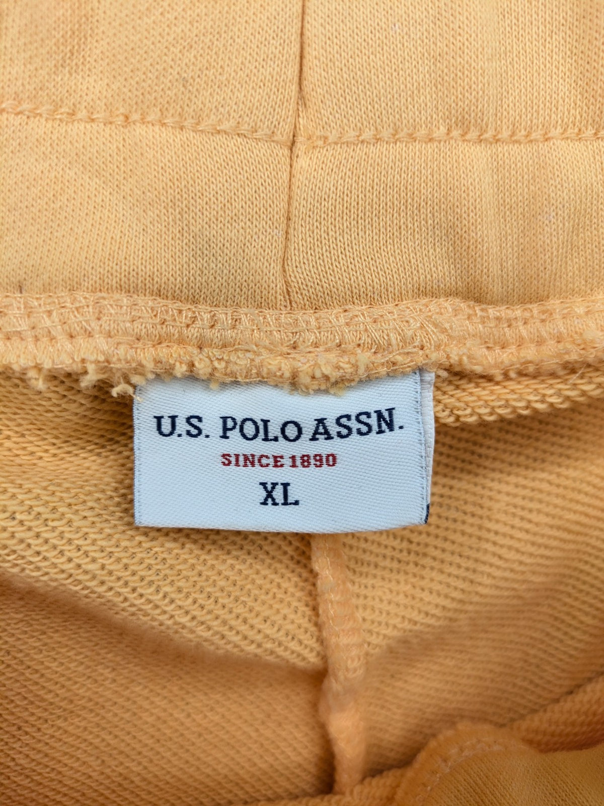 U.S. Polo Assn. orange sweatpants slim fit with sequin USPA logo on leg.