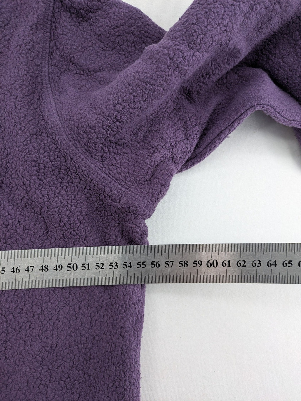 Waschbär pink and purple fleece jacket with red contrast details and high collar.