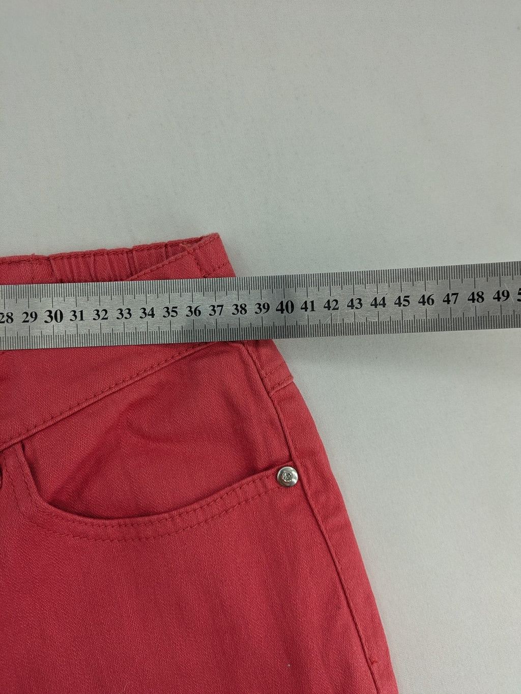 Helena Vera red straight jeans with elastic waistband and rhinestone details on pockets.