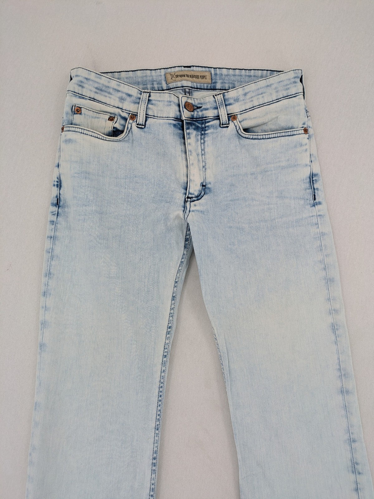 Drykorn blue slim fit jeans with acid wash and leather logo patch.