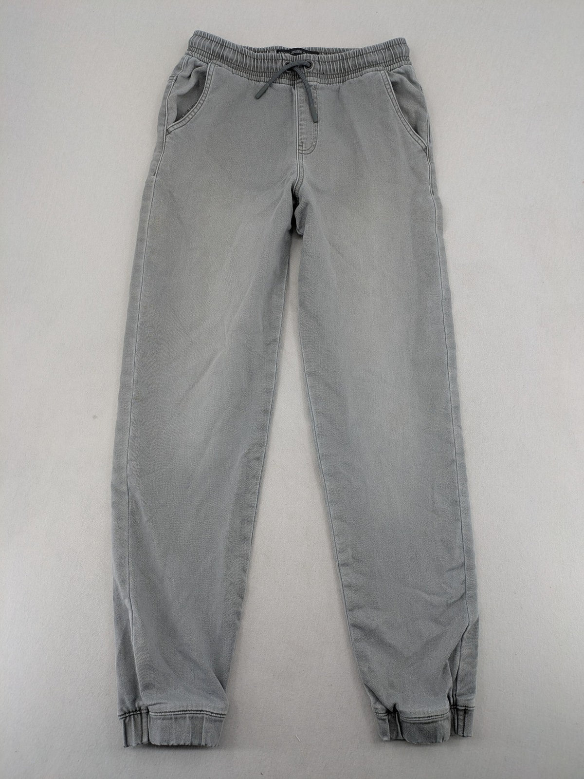 Denim & Co. grey jogger jeans with elastic waistband and ankle cuffs, cotton material.