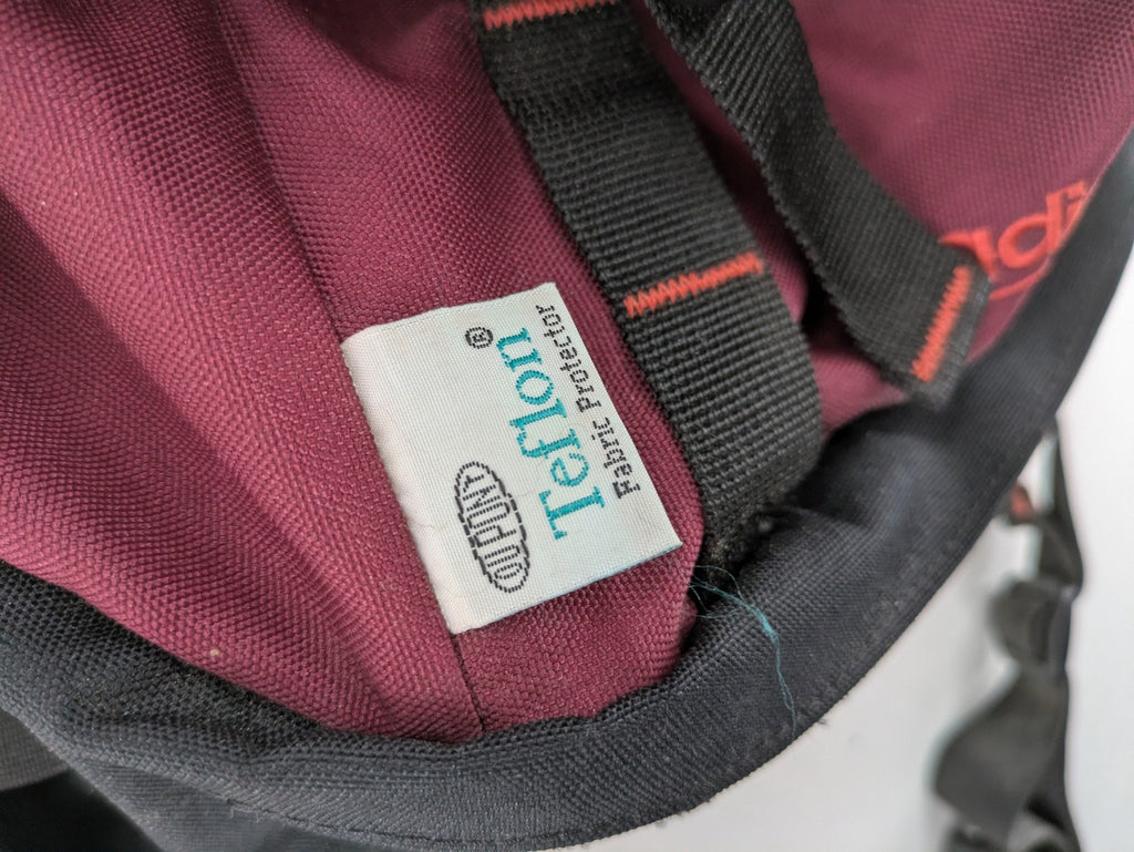 Adidas burgundy vintage rucksack with logo, Teflon fabric, and drawstring closure.