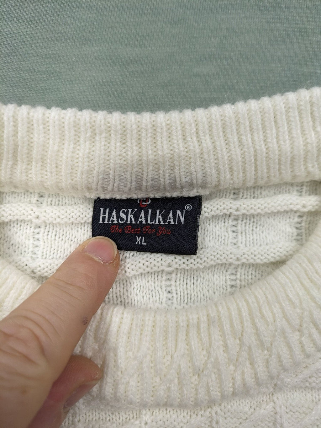 Haskalkan white turtle neck jumper with geometric textured pattern and ribbed cuffs.
