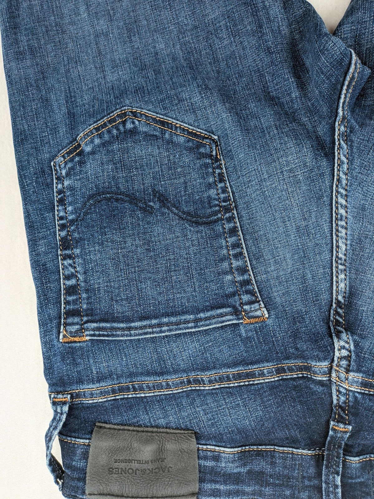 Jack & Jones blue slim fit jeans with faded wash and classic button fly.