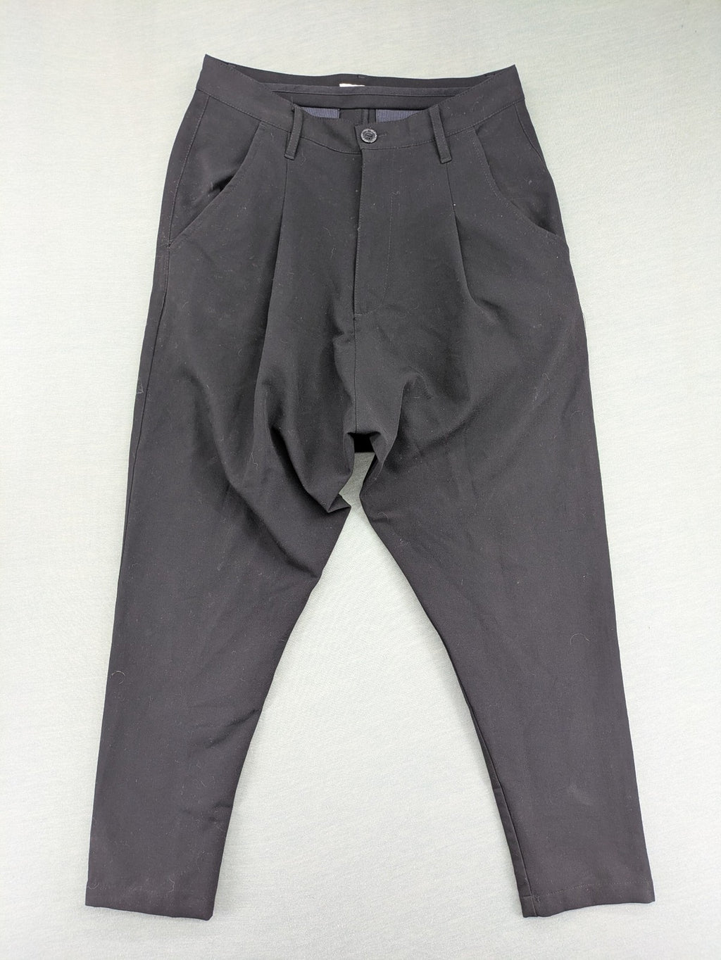 Jenny Joy pink harem pants with pleats, side pockets, and tapered legs.