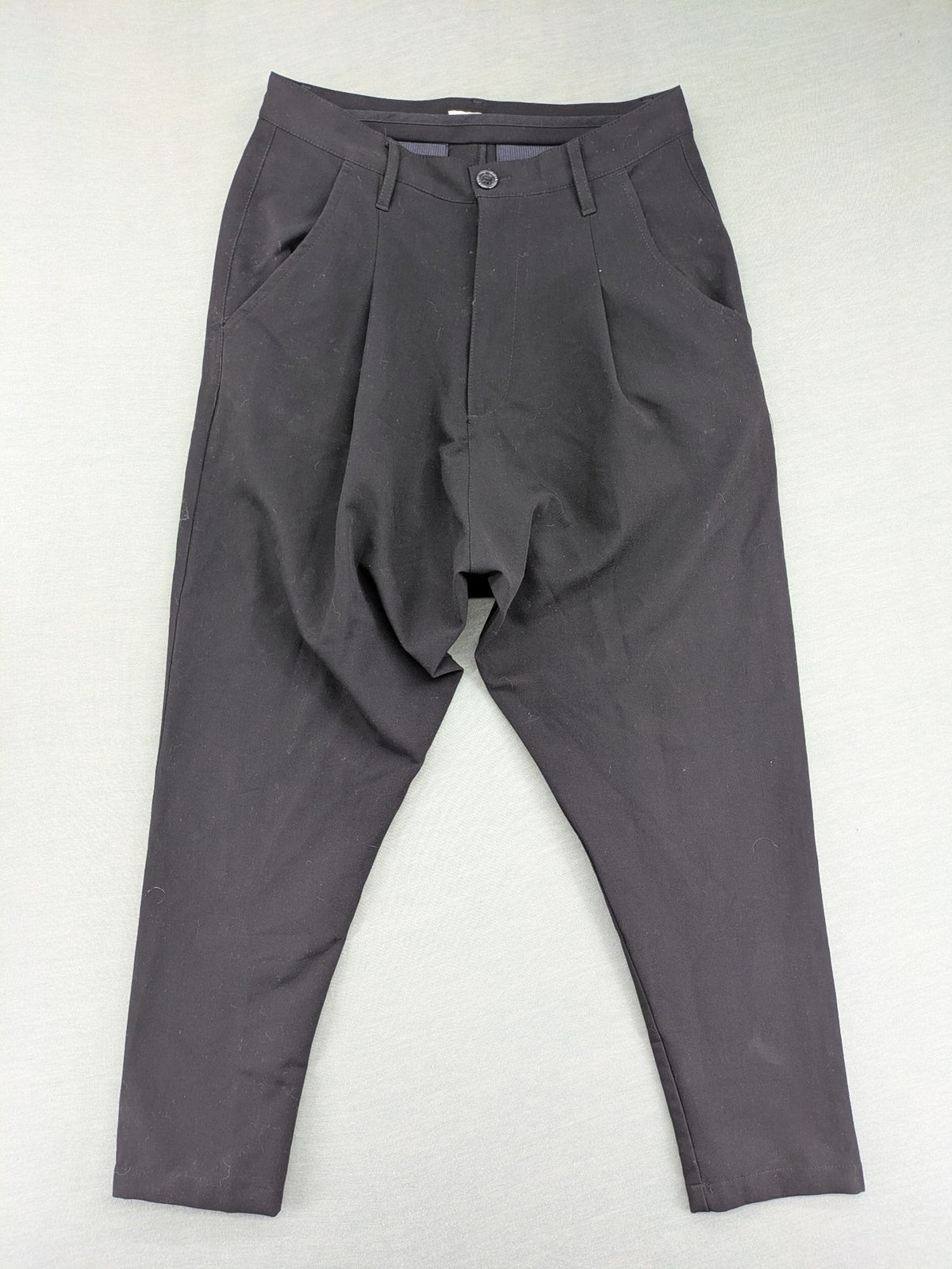 Jenny Joy pink harem pants with pleats, side pockets, and tapered legs.