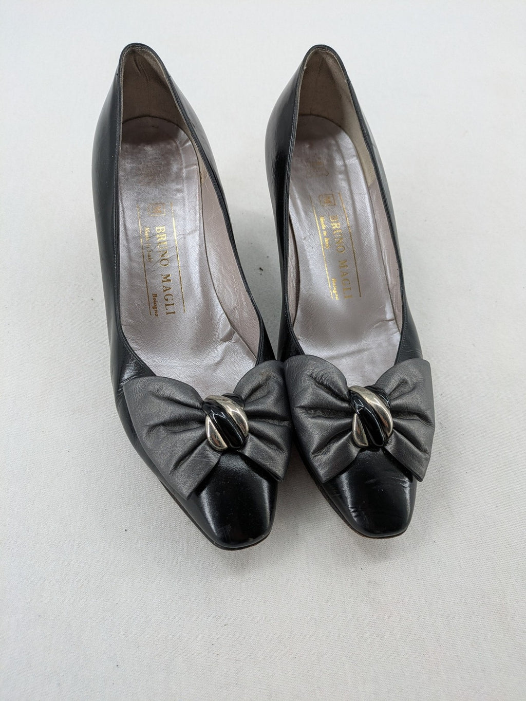 Bruno Magli black high heels leather with grey bow detail and classic silhouette.