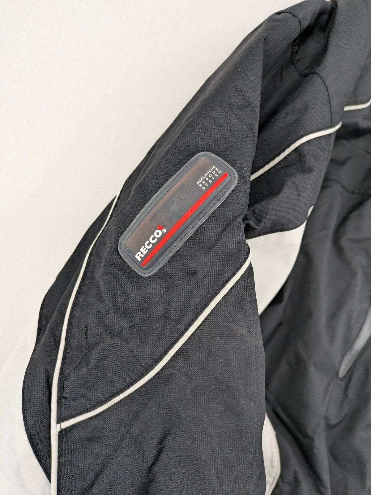 Icepeak black and white ski snowboard jacket with RECCO logo and quilted insulation.