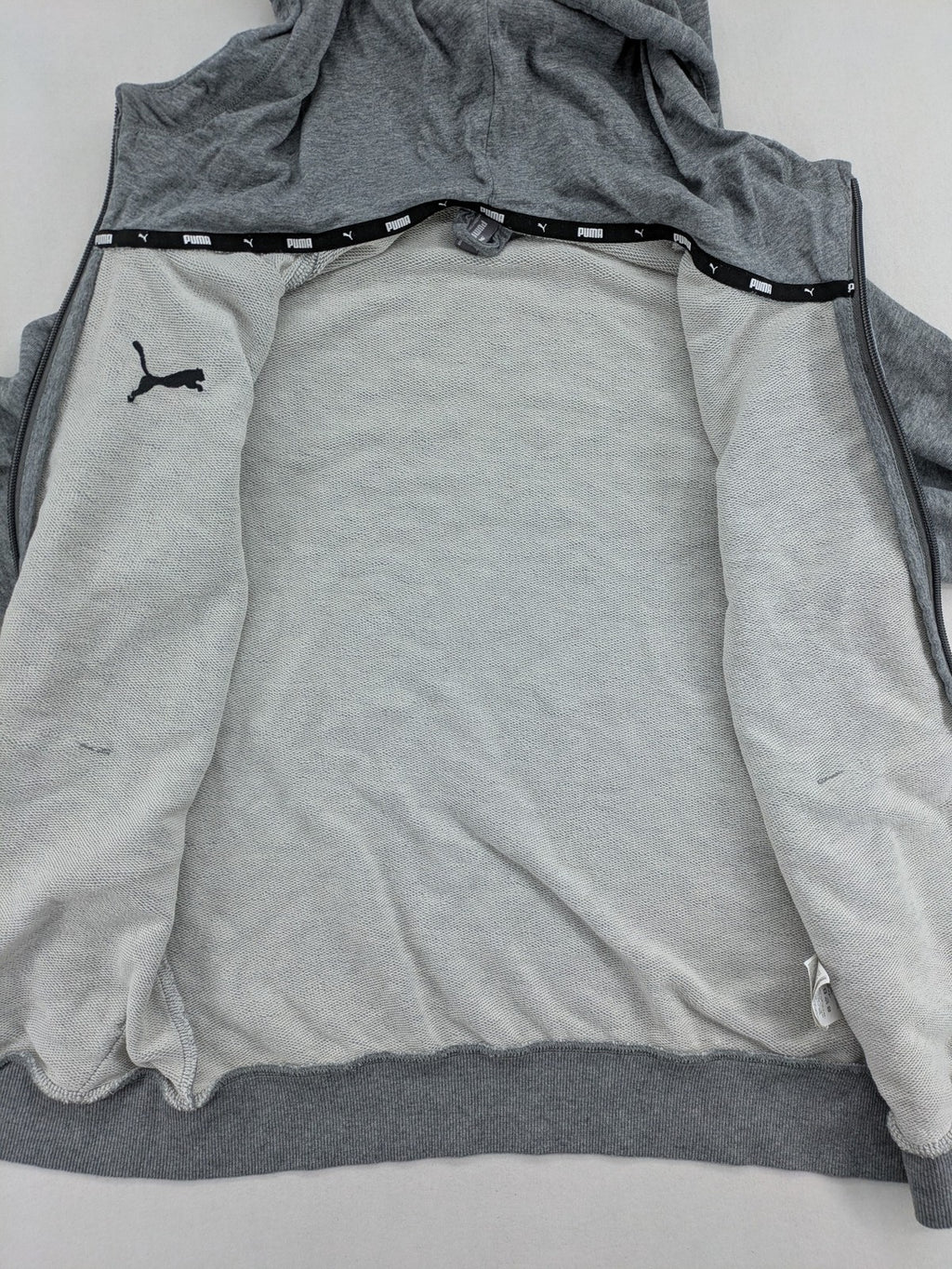 Puma grey full zip hoodie with adjustable drawstring hood and logo detail.