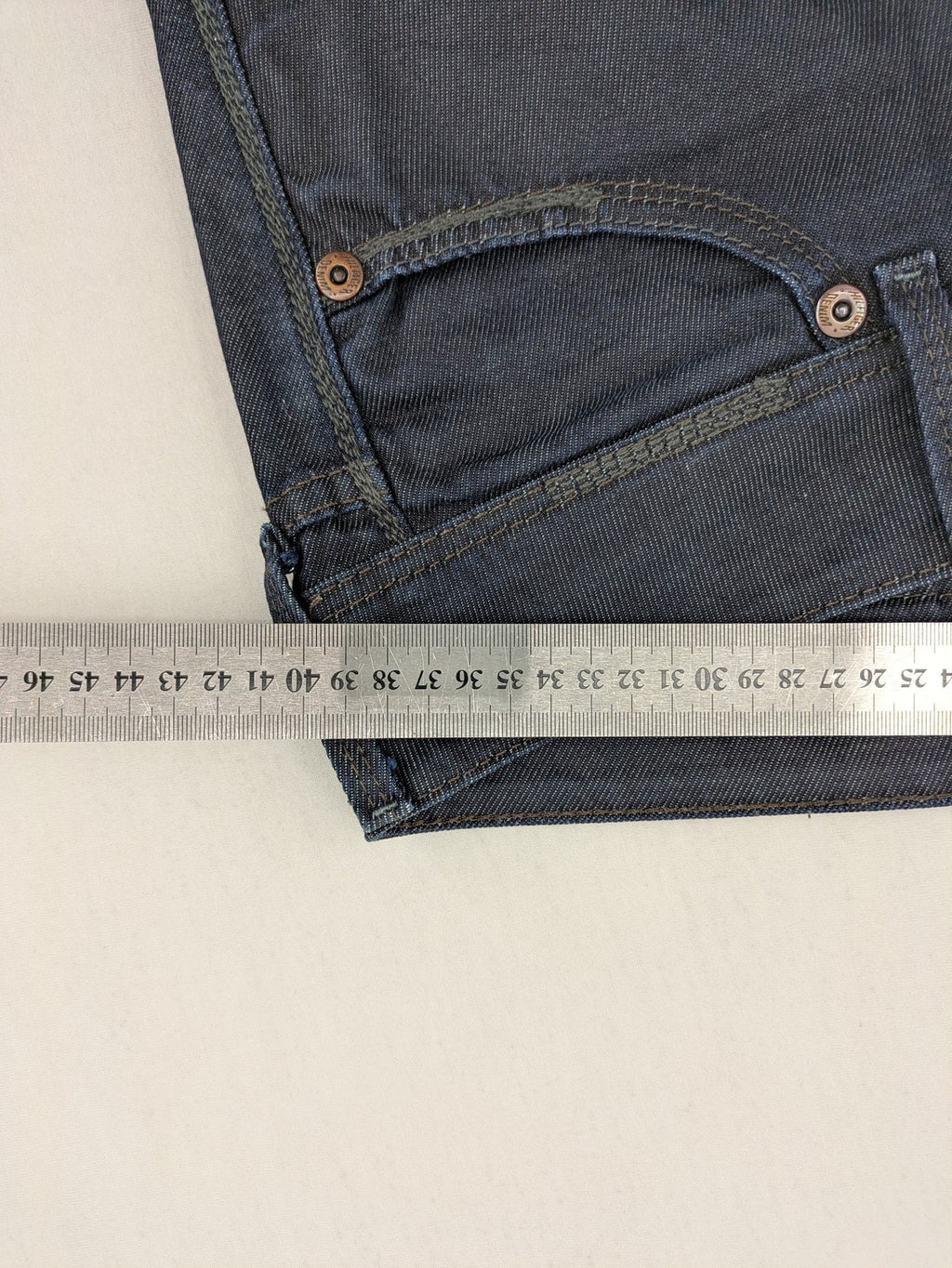 Hilfiger Denim blue straight jeans with double button closure and logo detail.