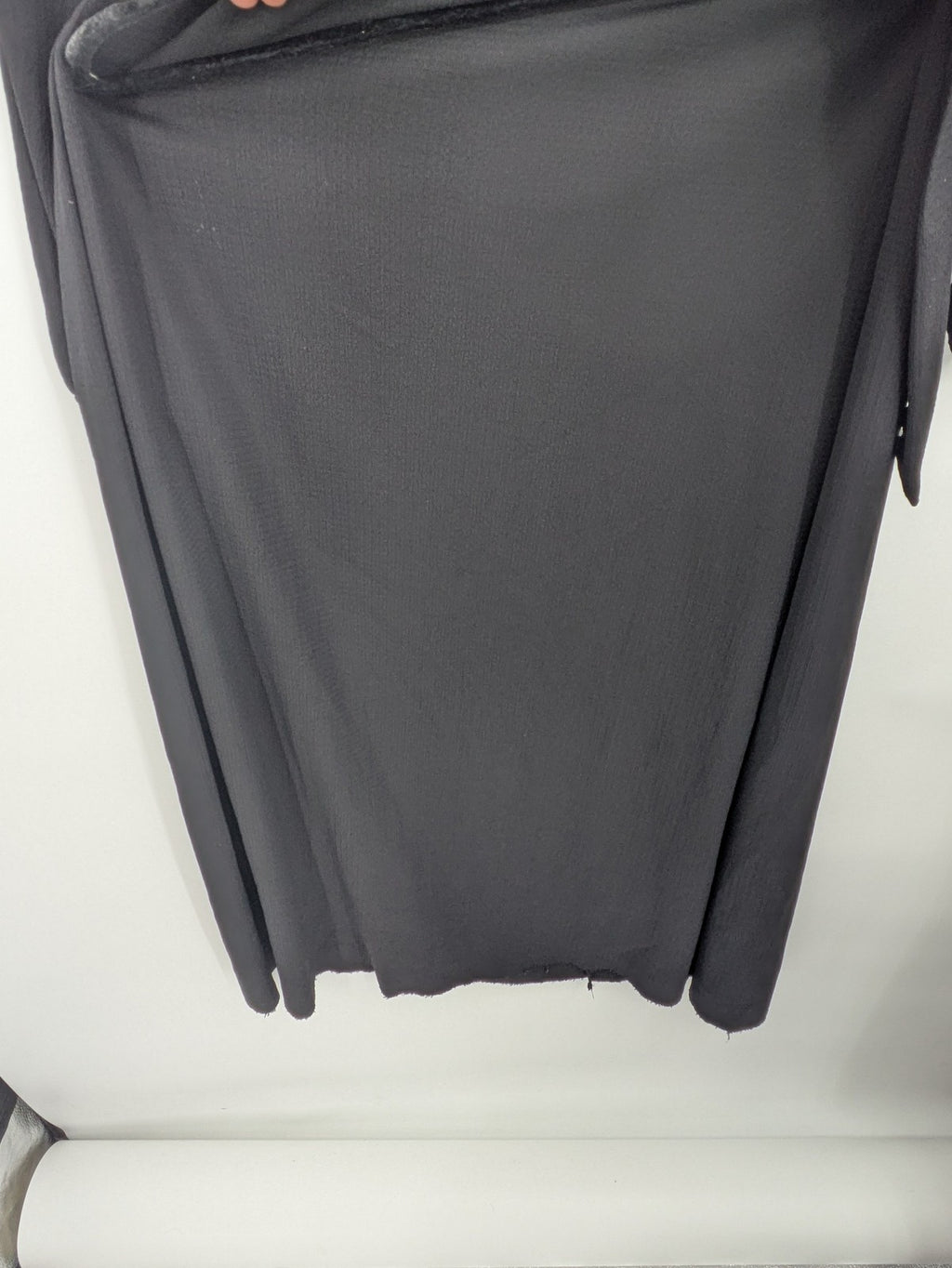 Hakke black maxi dress with ruffle details, long sleeves, and matching belt.
