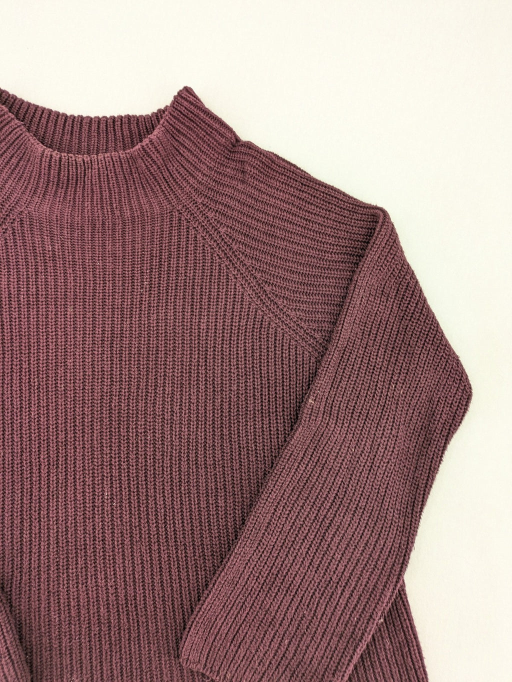 Monari burgundy knit jumper with standing collar, ribbed texture, and raglan sleeves.