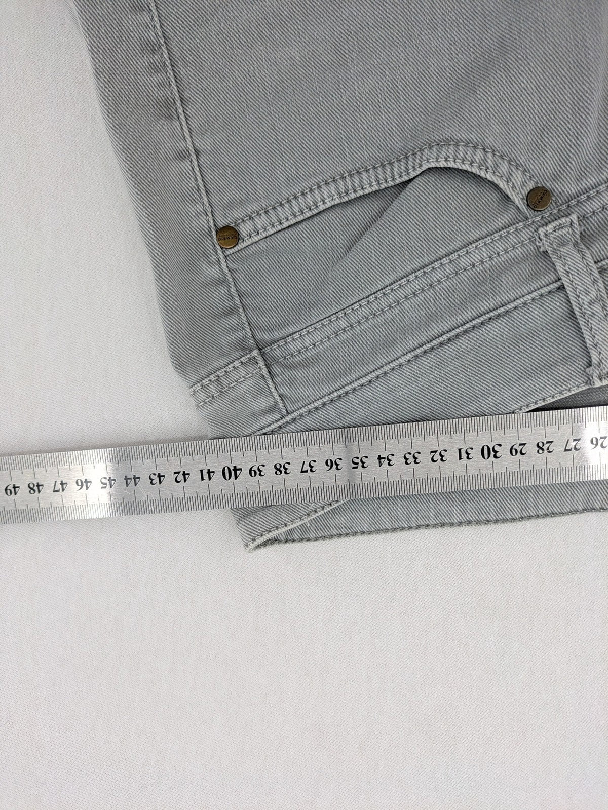 Cambio grey straight leg jeans with five-pocket design and logo button closure.