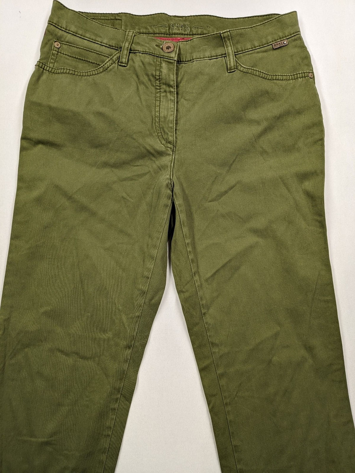 BRAX khaki pants classic five-pocket style with logo patch and zip button closure.