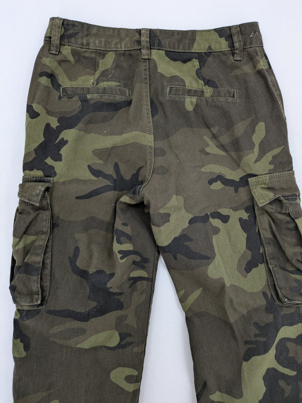 Rainbow camouflage cargo pants in green-brown with jogger silhouette and multiple pockets.